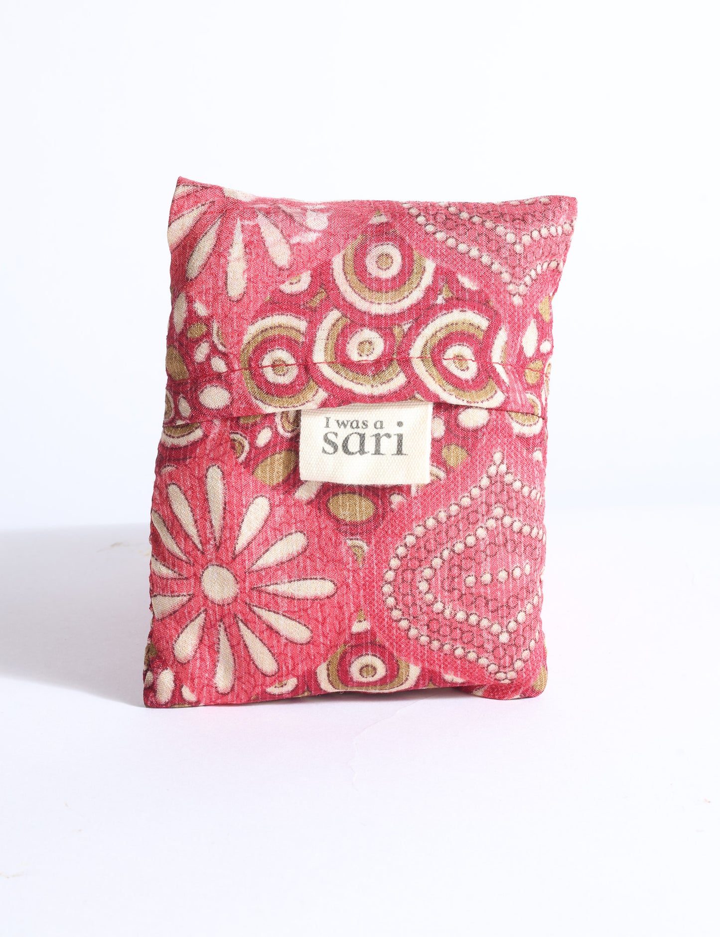 Blue reusable bag with multicolor tropical floral pattern folded with "I was a sari" label visible on front