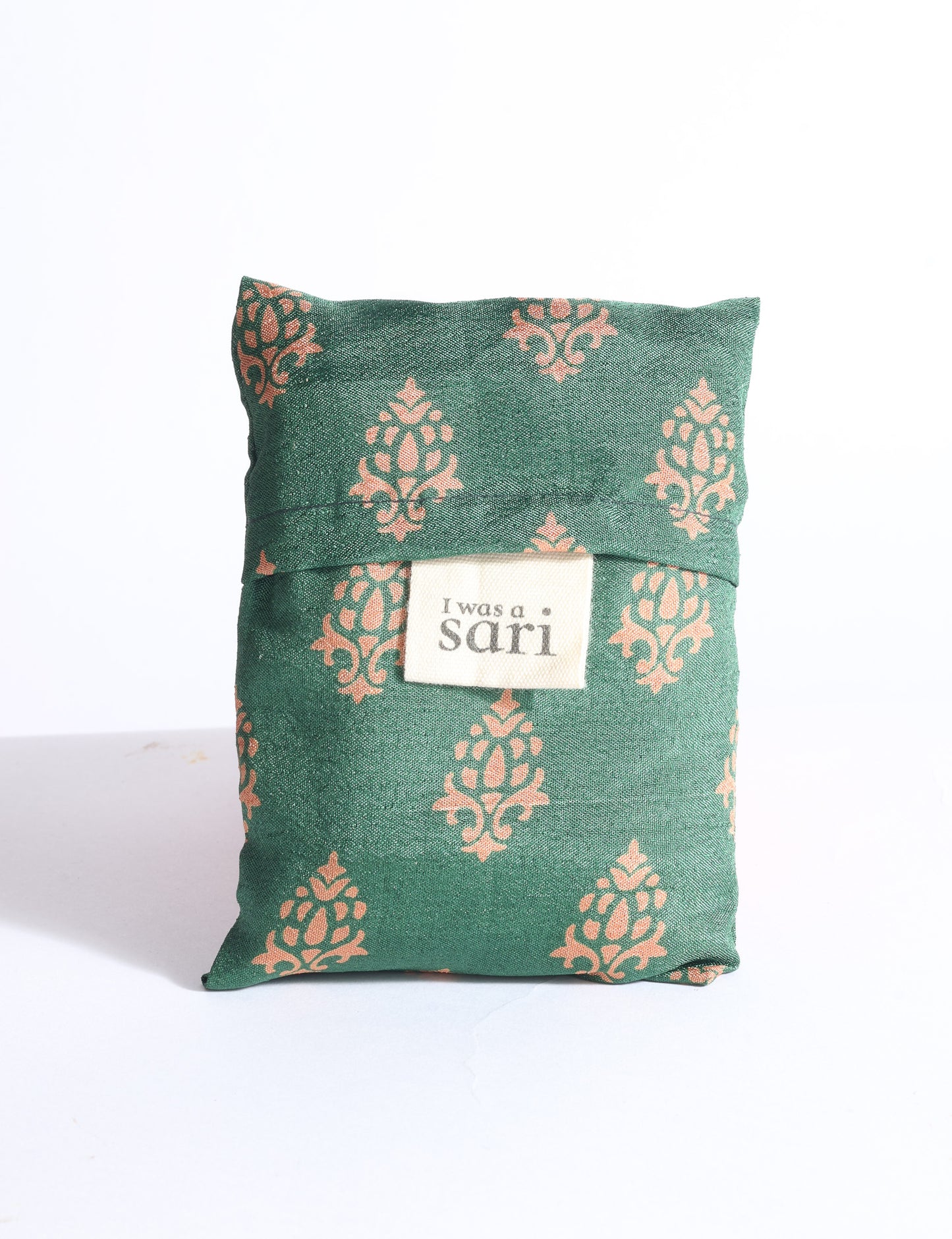 Blue reusable bag with multicolor tropical floral pattern folded with "I was a sari" label visible on front