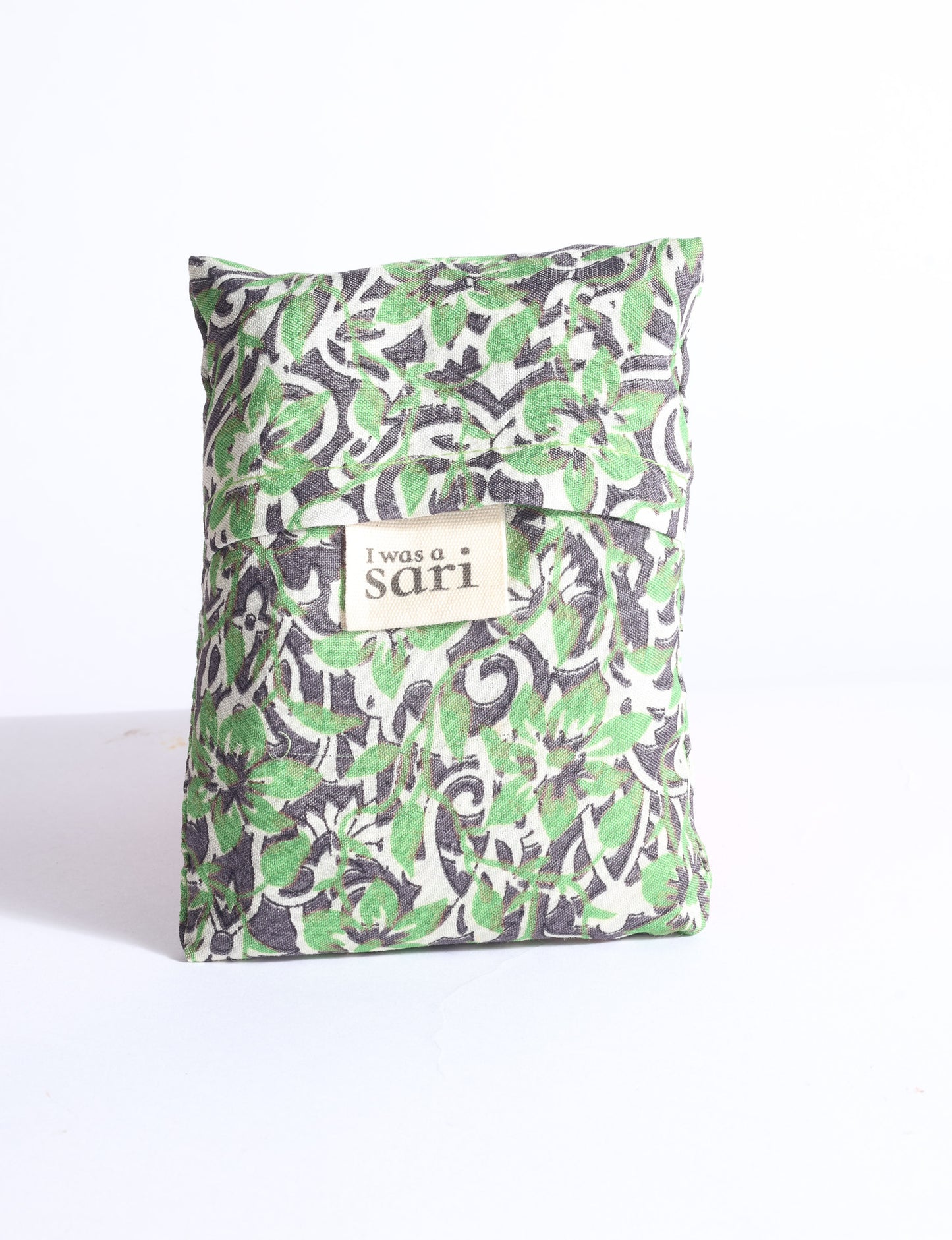 Blue reusable bag with multicolor tropical floral pattern folded with "I was a sari" label visible on front