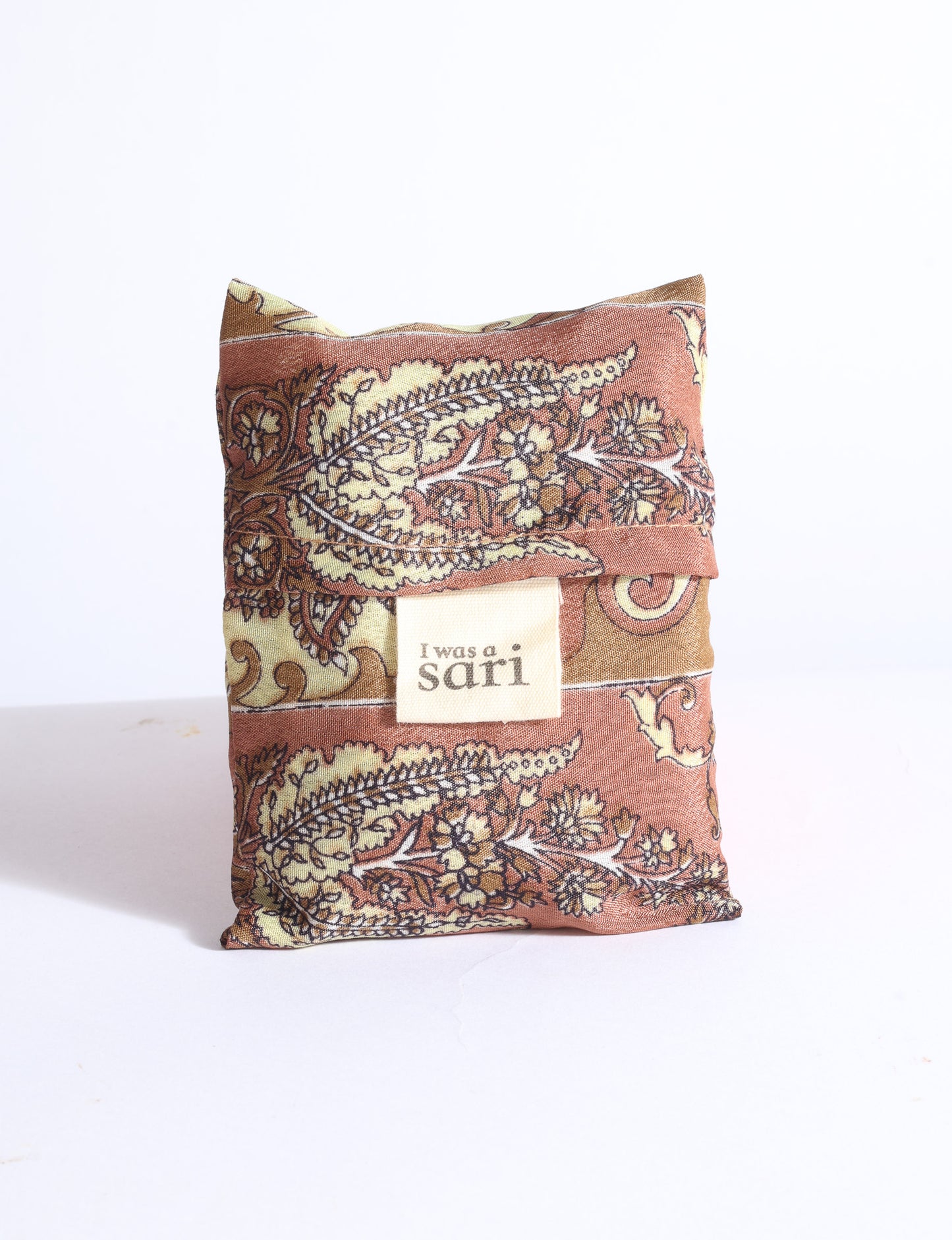 Blue reusable bag with multicolor tropical floral pattern folded with "I was a sari" label visible on front