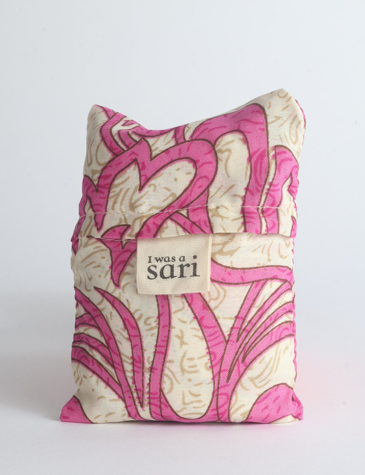 Blue reusable bag with multicolor tropical floral pattern folded with "I was a sari" label visible on front
