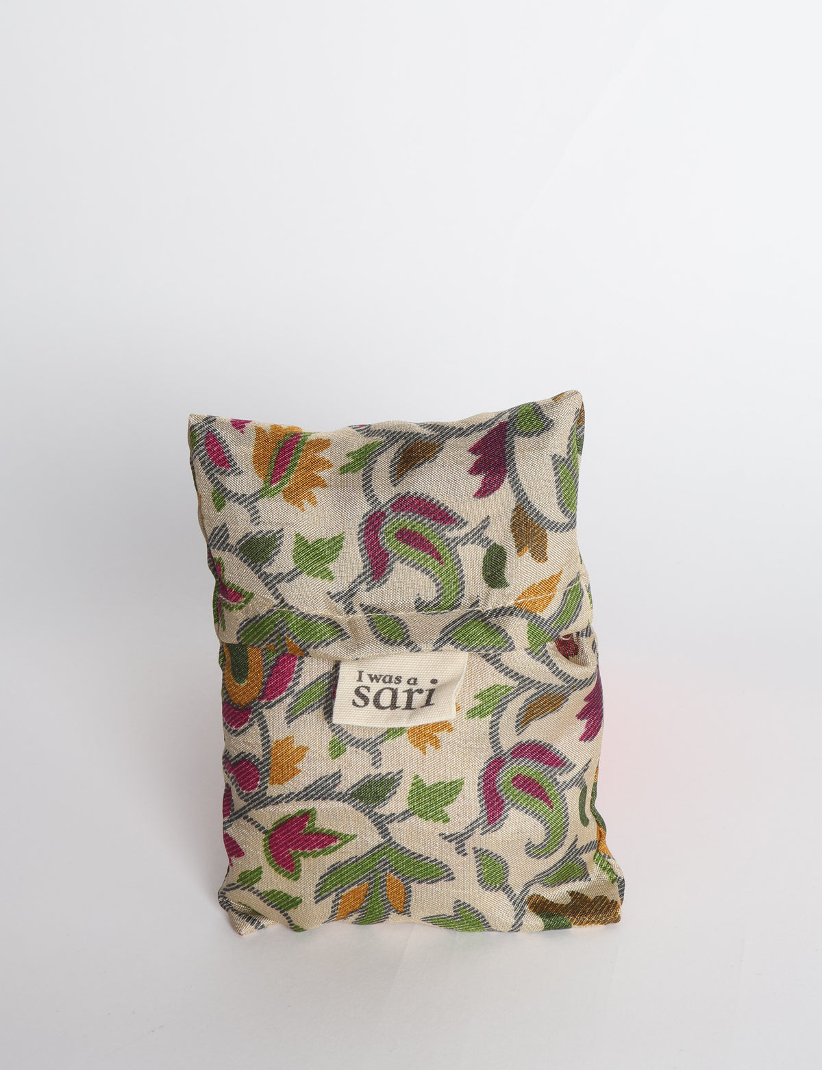 Blue reusable bag with multicolor tropical floral pattern folded with "I was a sari" label visible on front