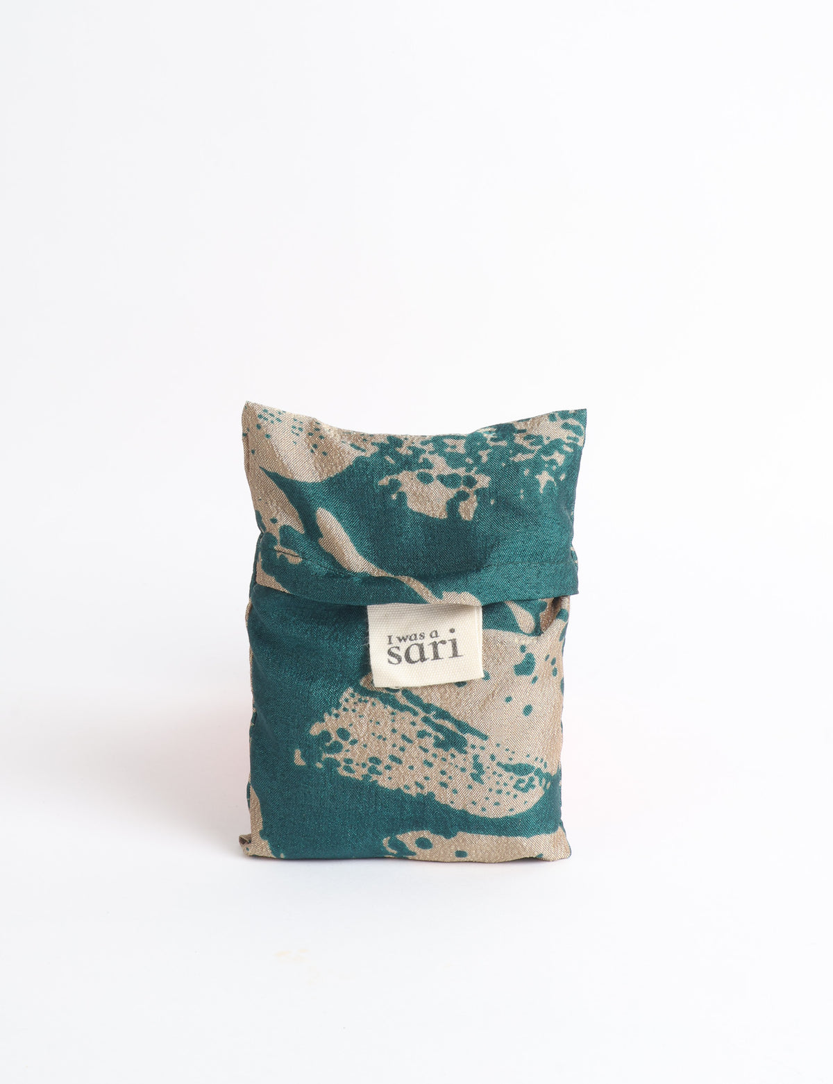 Blue reusable bag with multicolor tropical floral pattern folded with "I was a sari" label visible on front