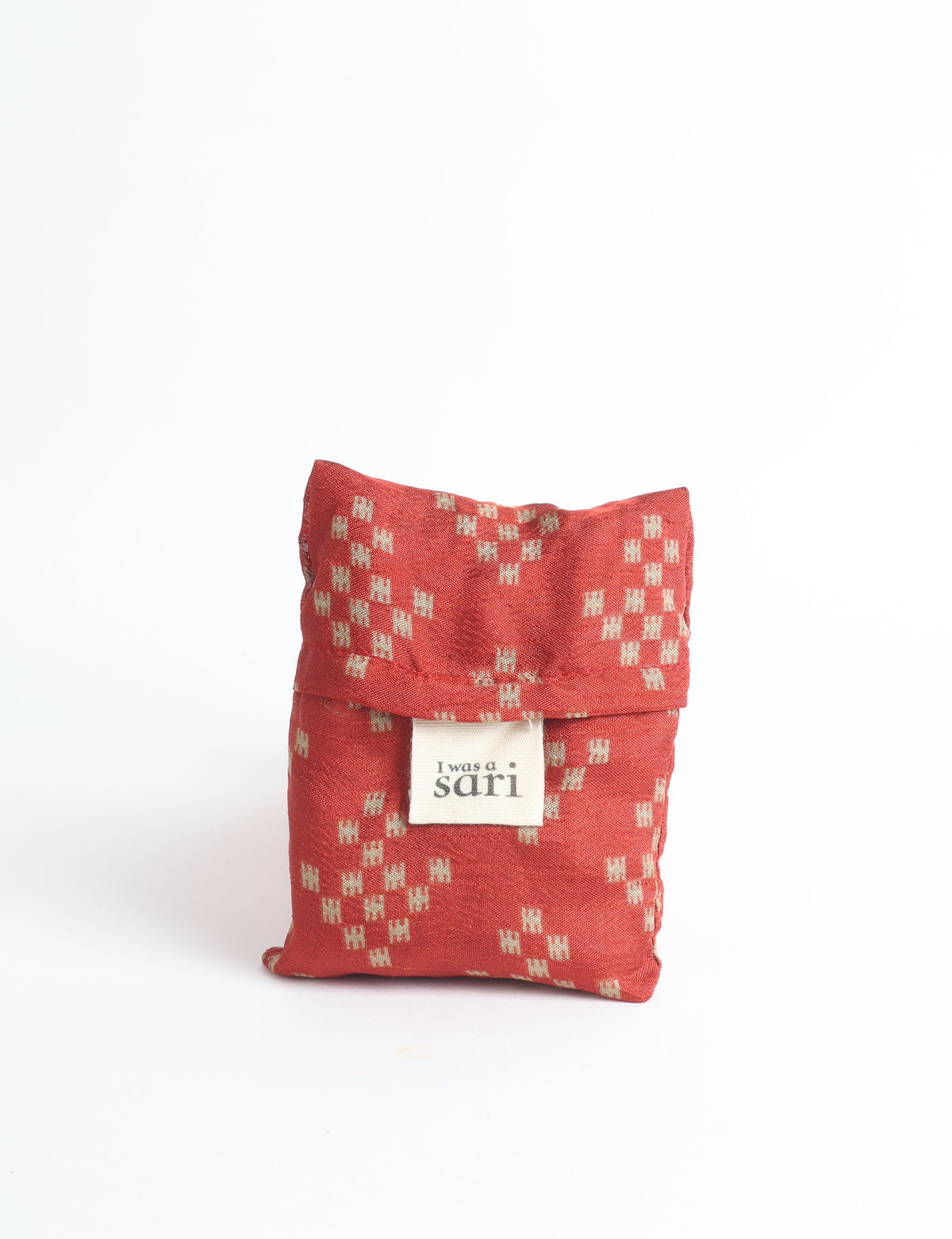 Blue reusable bag with multicolor tropical floral pattern folded with "I was a sari" label visible on front