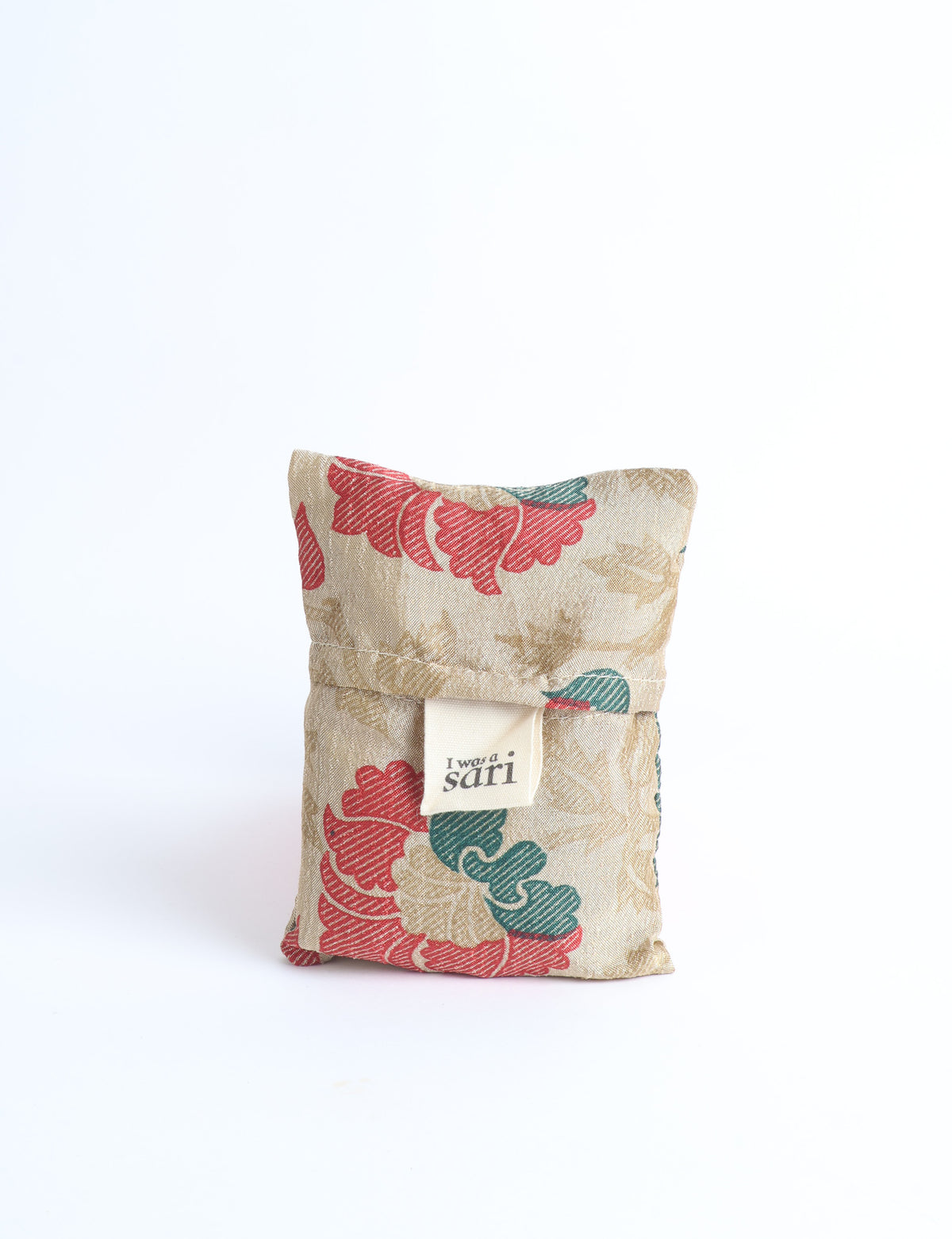 Blue reusable bag with multicolor tropical floral pattern folded with "I was a sari" label visible on front