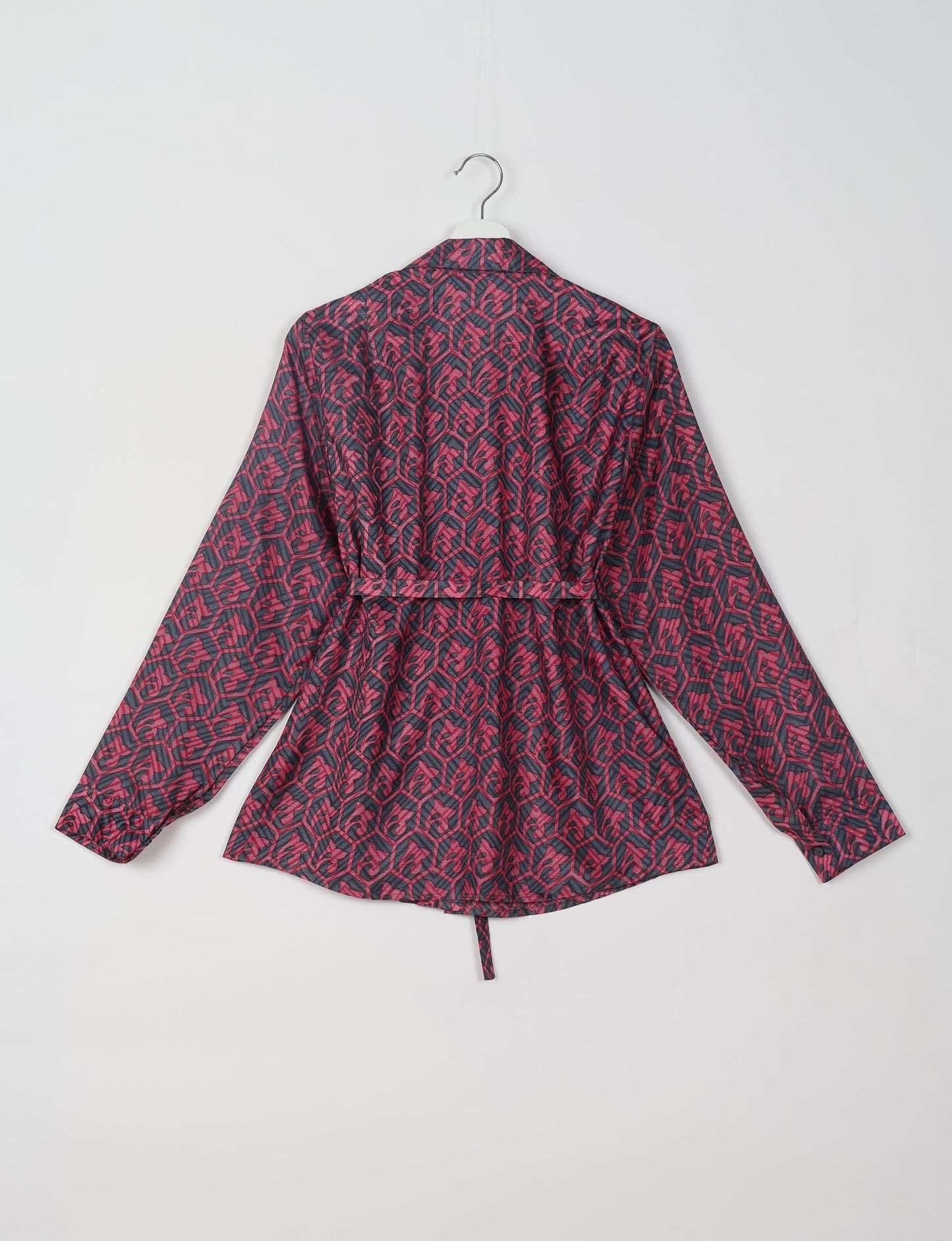 Experience sustainable fashion with our classic slim-fit shirt, crafted with ethical and green values. The shirt, designed for minimal waste, features a tie-up waist belt or neck tie, semi-spread collar, and regular shirt cuffs. Versatile and eco-friendly, wear it tucked in, unbuttoned over a tank top, or knotted at the waist for a unique style.