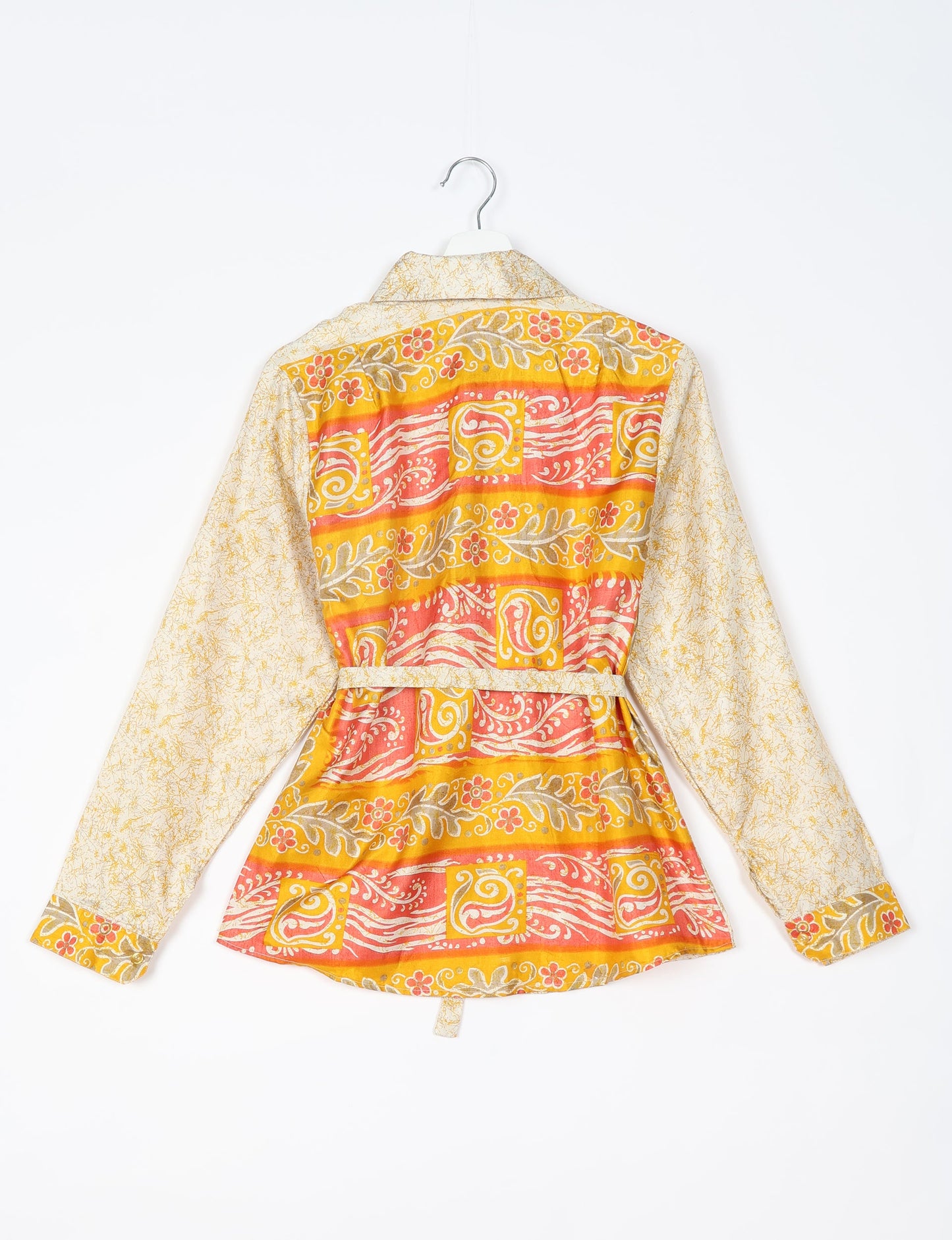 Experience sustainable fashion with our classic slim-fit shirt, crafted with ethical and green values. The shirt, designed for minimal waste, features a tie-up waist belt or neck tie, semi-spread collar, and regular shirt cuffs. Versatile and eco-friendly, wear it tucked in, unbuttoned over a tank top, or knotted at the waist for a unique style.