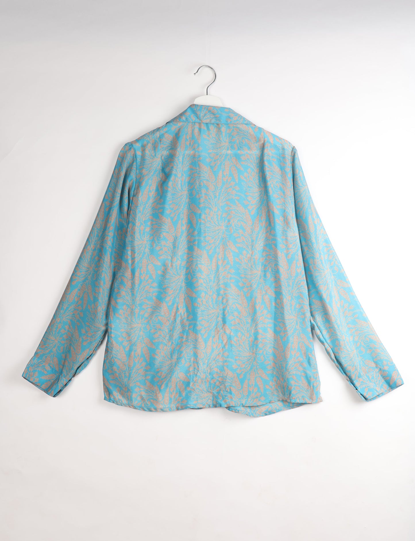 Experience sustainable fashion with our classic slim-fit shirt, crafted with ethical and green values. The shirt, designed for minimal waste, features a tie-up waist belt or neck tie, semi-spread collar, and regular shirt cuffs. Versatile and eco-friendly, wear it tucked in, unbuttoned over a tank top, or knotted at the waist for a unique style.