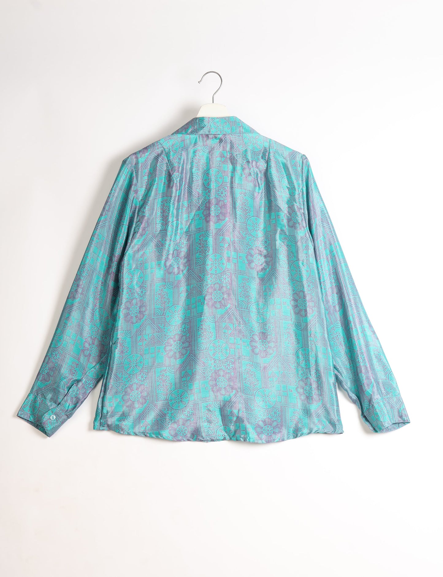 Experience sustainable fashion with our classic slim-fit shirt, crafted with ethical and green values. The shirt, designed for minimal waste, features a tie-up waist belt or neck tie, semi-spread collar, and regular shirt cuffs. Versatile and eco-friendly, wear it tucked in, unbuttoned over a tank top, or knotted at the waist for a unique style.