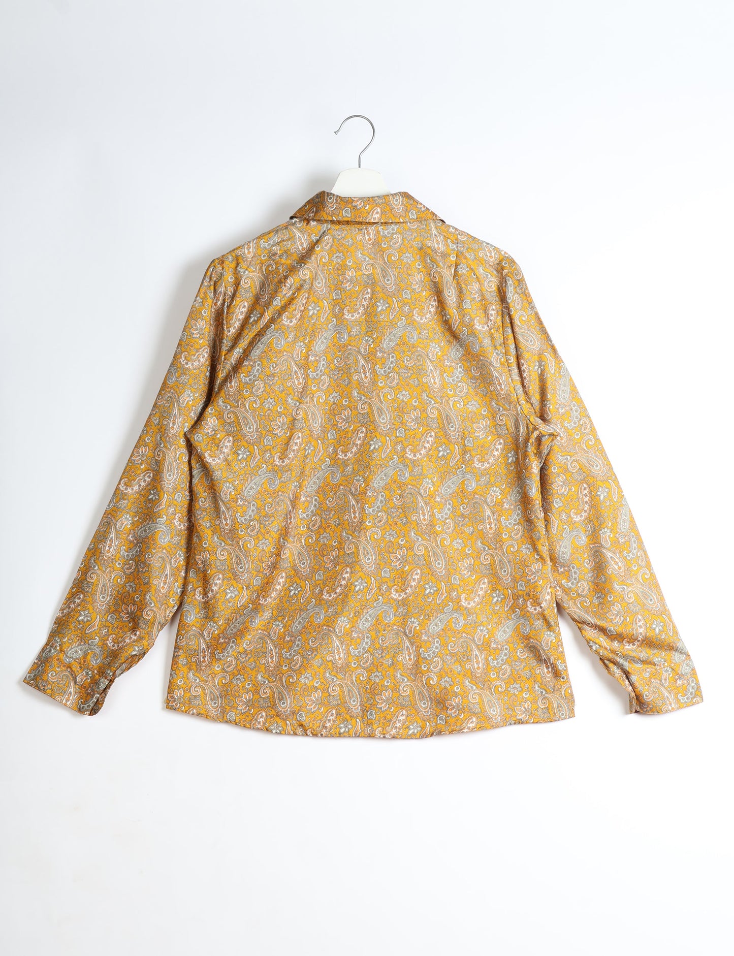 Experience sustainable fashion with our classic slim-fit shirt, crafted with ethical and green values. The shirt, designed for minimal waste, features a tie-up waist belt or neck tie, semi-spread collar, and regular shirt cuffs. Versatile and eco-friendly, wear it tucked in, unbuttoned over a tank top, or knotted at the waist for a unique style.