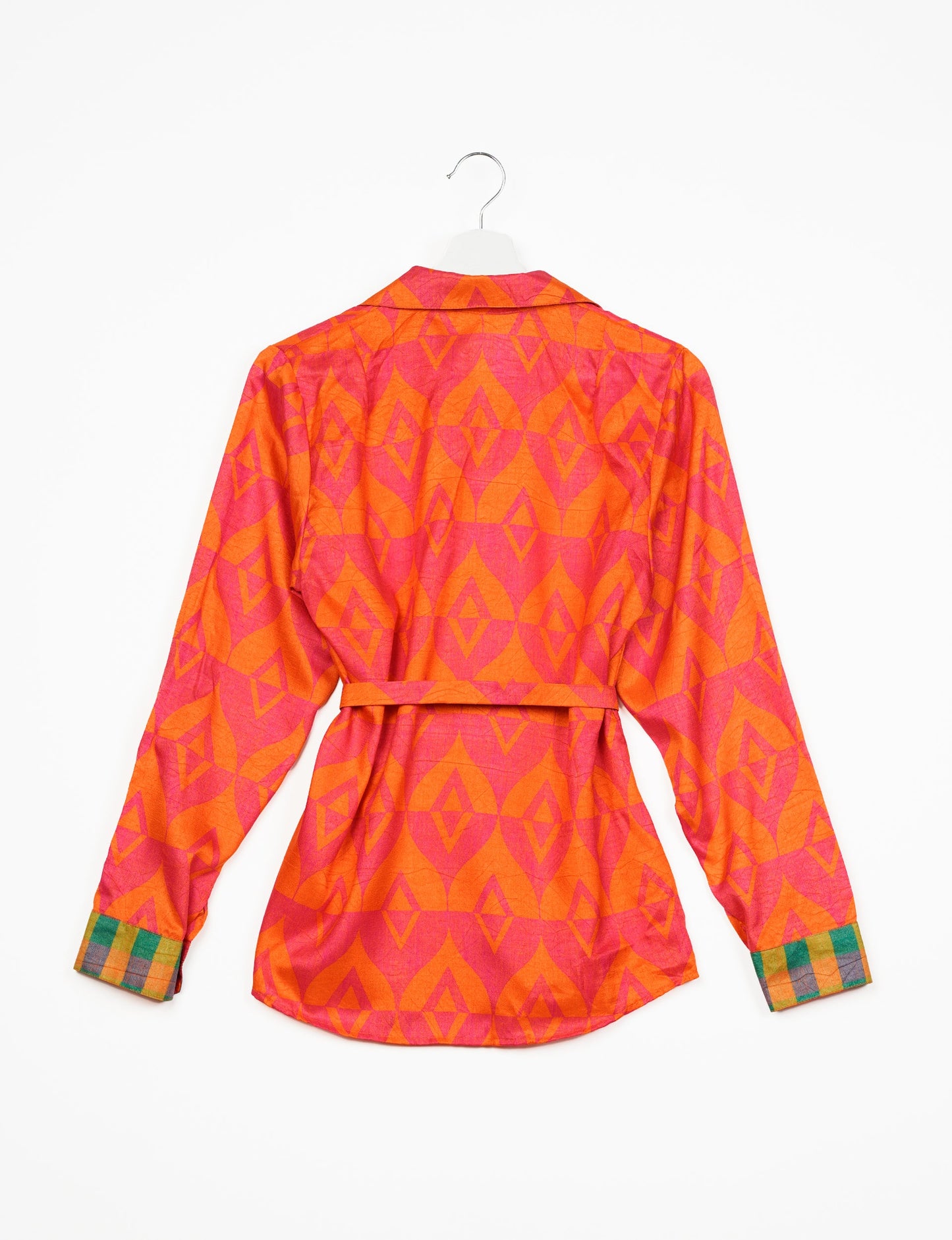 Experience sustainable fashion with our classic slim-fit shirt, crafted with ethical and green values. The shirt, designed for minimal waste, features a tie-up waist belt or neck tie, semi-spread collar, and regular shirt cuffs. Versatile and eco-friendly, wear it tucked in, unbuttoned over a tank top, or knotted at the waist for a unique style.