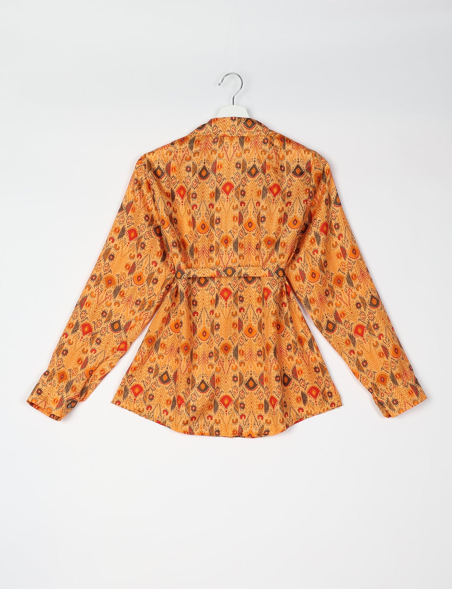 Experience sustainable fashion with our classic slim-fit shirt, crafted with ethical and green values. The shirt, designed for minimal waste, features a tie-up waist belt or neck tie, semi-spread collar, and regular shirt cuffs. Versatile and eco-friendly, wear it tucked in, unbuttoned over a tank top, or knotted at the waist for a unique style.