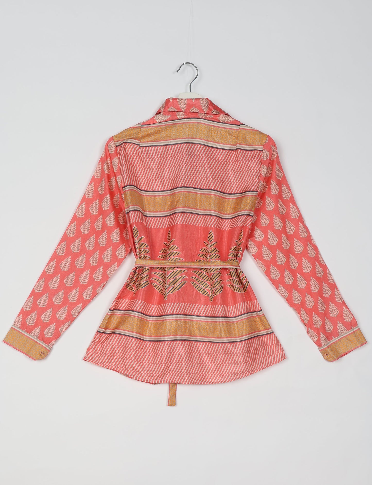 Experience sustainable fashion with our classic slim-fit shirt, crafted with ethical and green values. The shirt, designed for minimal waste, features a tie-up waist belt or neck tie, semi-spread collar, and regular shirt cuffs. Versatile and eco-friendly, wear it tucked in, unbuttoned over a tank top, or knotted at the waist for a unique style.