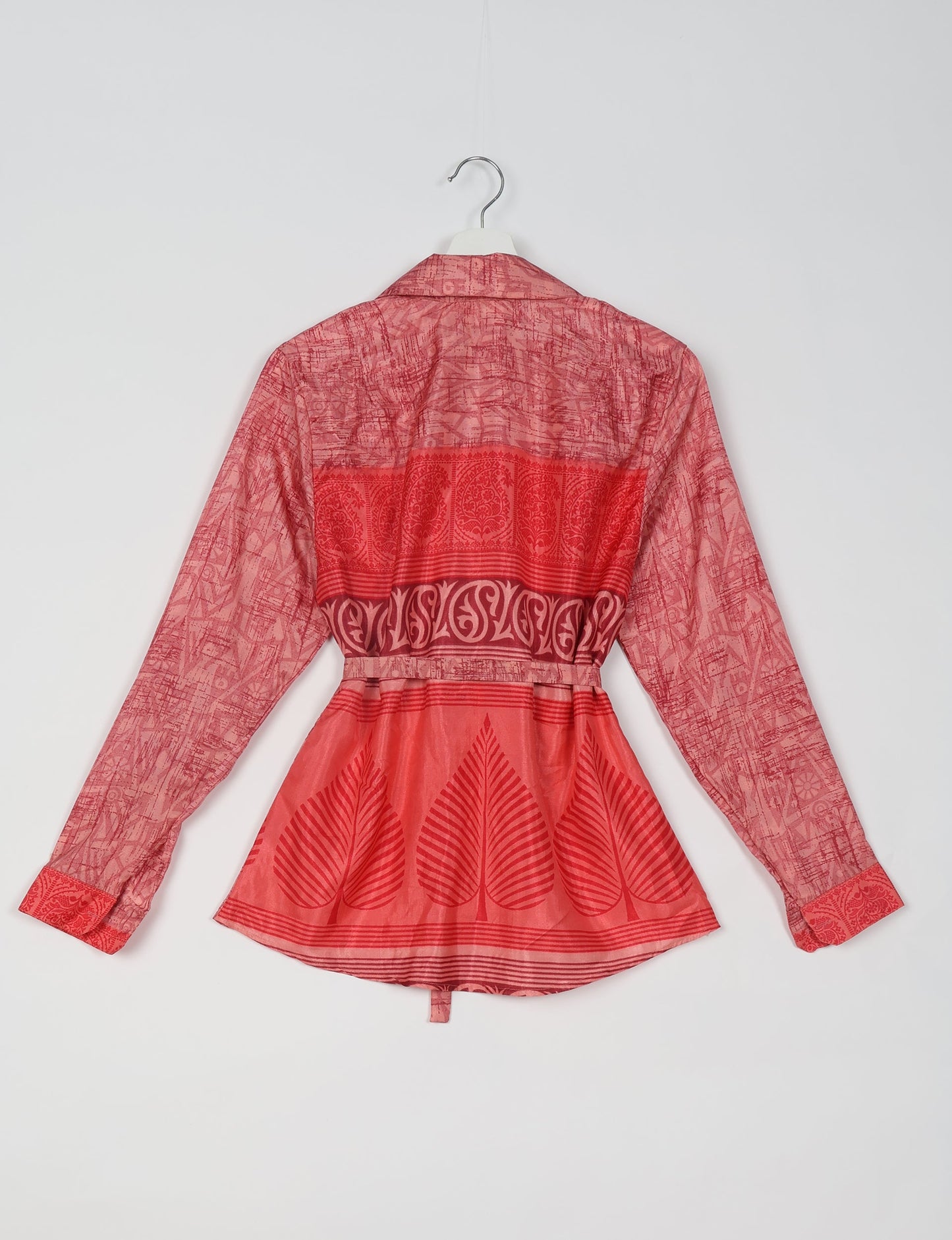 Experience sustainable fashion with our classic slim-fit shirt, crafted with ethical and green values. The shirt, designed for minimal waste, features a tie-up waist belt or neck tie, semi-spread collar, and regular shirt cuffs. Versatile and eco-friendly, wear it tucked in, unbuttoned over a tank top, or knotted at the waist for a unique style.