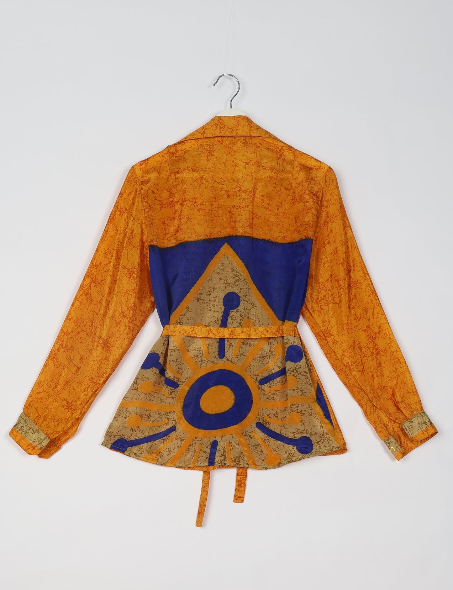 Experience sustainable fashion with our classic slim-fit shirt, crafted with ethical and green values. The shirt, designed for minimal waste, features a tie-up waist belt or neck tie, semi-spread collar, and regular shirt cuffs. Versatile and eco-friendly, wear it tucked in, unbuttoned over a tank top, or knotted at the waist for a unique style.