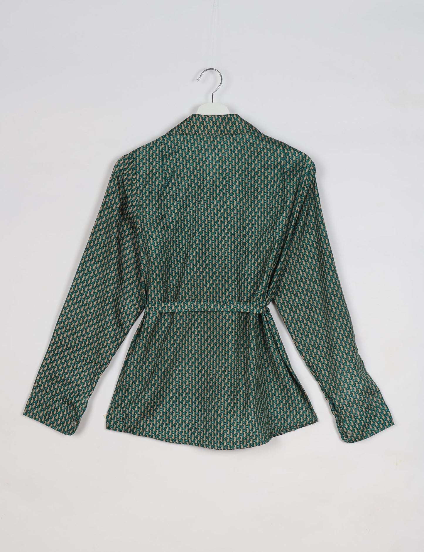 Experience sustainable fashion with our classic slim-fit shirt, crafted with ethical and green values. The shirt, designed for minimal waste, features a tie-up waist belt or neck tie, semi-spread collar, and regular shirt cuffs. Versatile and eco-friendly, wear it tucked in, unbuttoned over a tank top, or knotted at the waist for a unique style.