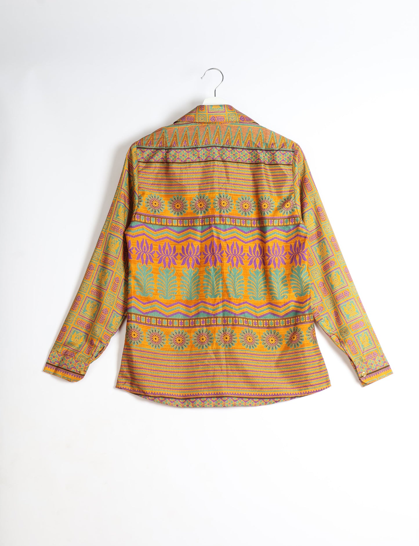 Experience sustainable fashion with our classic slim-fit shirt, crafted with ethical and green values. The shirt, designed for minimal waste, features a tie-up waist belt or neck tie, semi-spread collar, and regular shirt cuffs. Versatile and eco-friendly, wear it tucked in, unbuttoned over a tank top, or knotted at the waist for a unique style.