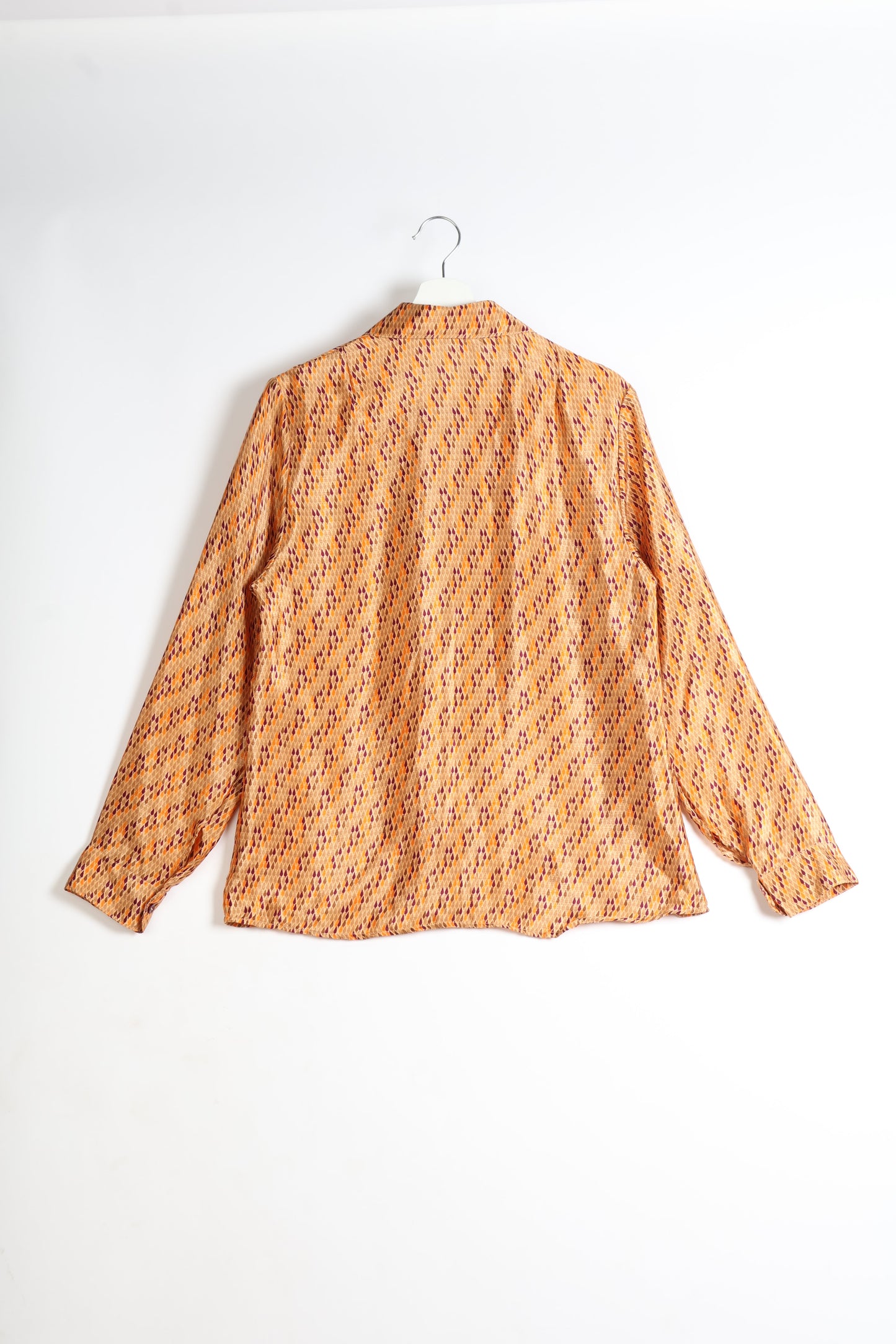 Experience sustainable fashion with our classic slim-fit shirt, crafted with ethical and green values. The shirt, designed for minimal waste, features a tie-up waist belt or neck tie, semi-spread collar, and regular shirt cuffs. Versatile and eco-friendly, wear it tucked in, unbuttoned over a tank top, or knotted at the waist for a unique style.