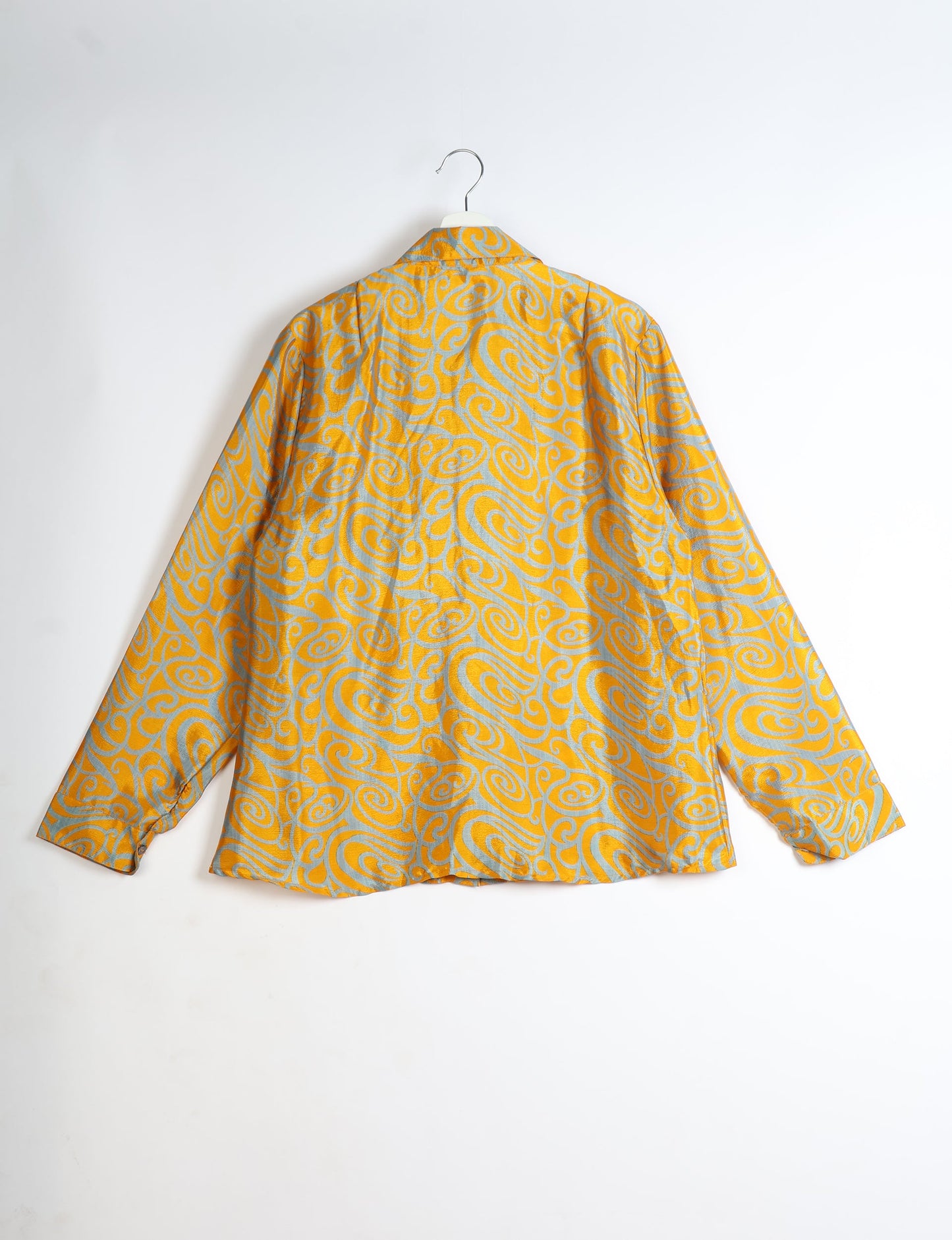 Experience sustainable fashion with our classic slim-fit shirt, crafted with ethical and green values. The shirt, designed for minimal waste, features a tie-up waist belt or neck tie, semi-spread collar, and regular shirt cuffs. Versatile and eco-friendly, wear it tucked in, unbuttoned over a tank top, or knotted at the waist for a unique style.