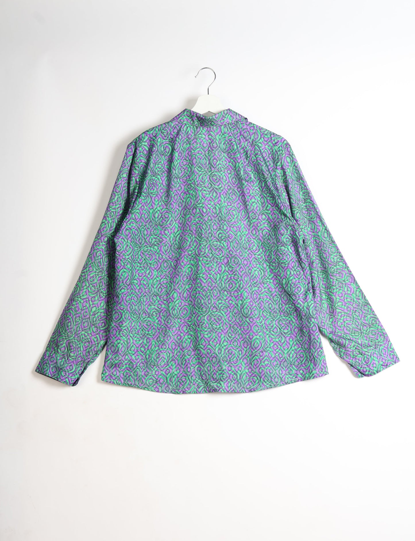 Experience sustainable fashion with our classic slim-fit shirt, crafted with ethical and green values. The shirt, designed for minimal waste, features a tie-up waist belt or neck tie, semi-spread collar, and regular shirt cuffs. Versatile and eco-friendly, wear it tucked in, unbuttoned over a tank top, or knotted at the waist for a unique style.