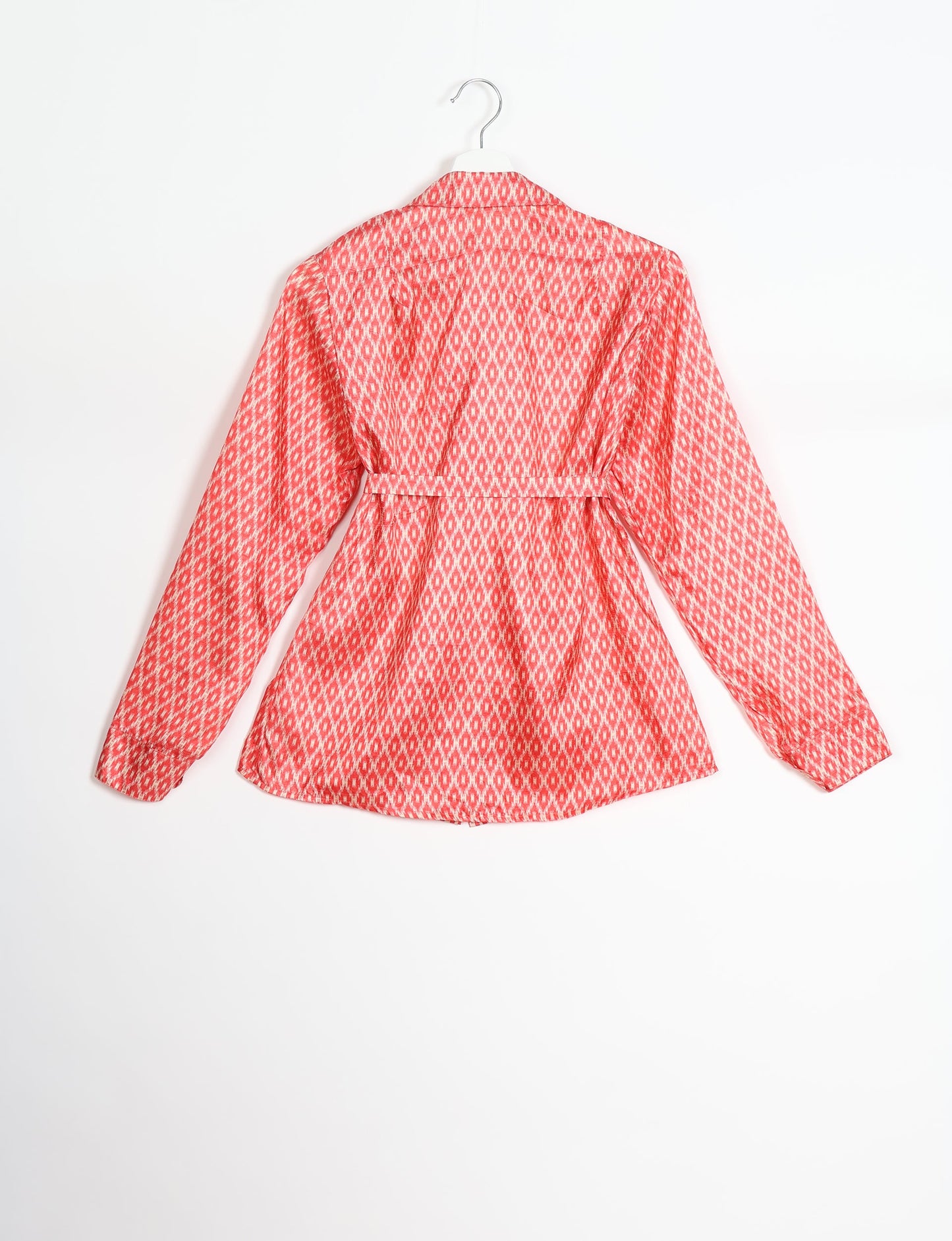 Experience sustainable fashion with our classic slim-fit shirt, crafted with ethical and green values. The shirt, designed for minimal waste, features a tie-up waist belt or neck tie, semi-spread collar, and regular shirt cuffs. Versatile and eco-friendly, wear it tucked in, unbuttoned over a tank top, or knotted at the waist for a unique style.