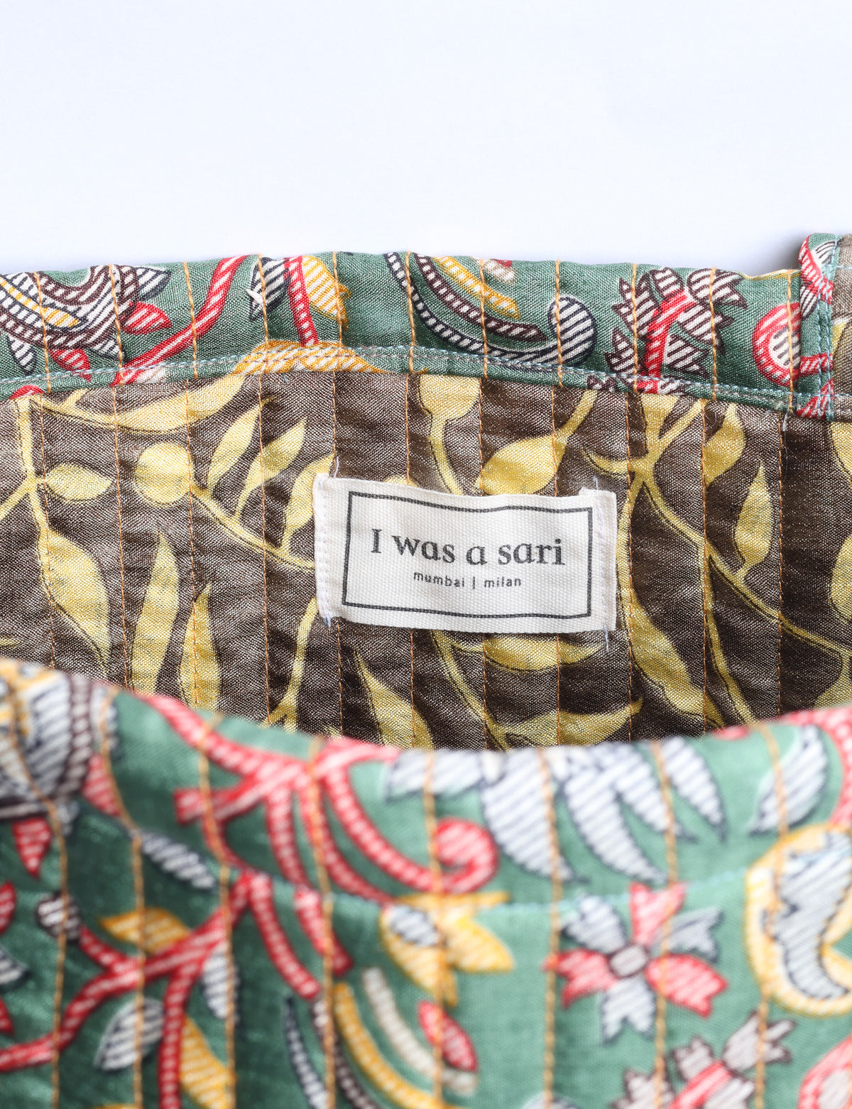 Elevate your style sustainably with our QUILTED SHOPPER BAG. Soft textures, vibrant colors, and a positive impact on people and the planet. Perfect for the office, shopping, or happy hour. Crafted from pre-loved saris for eco-conscious fashionistas!