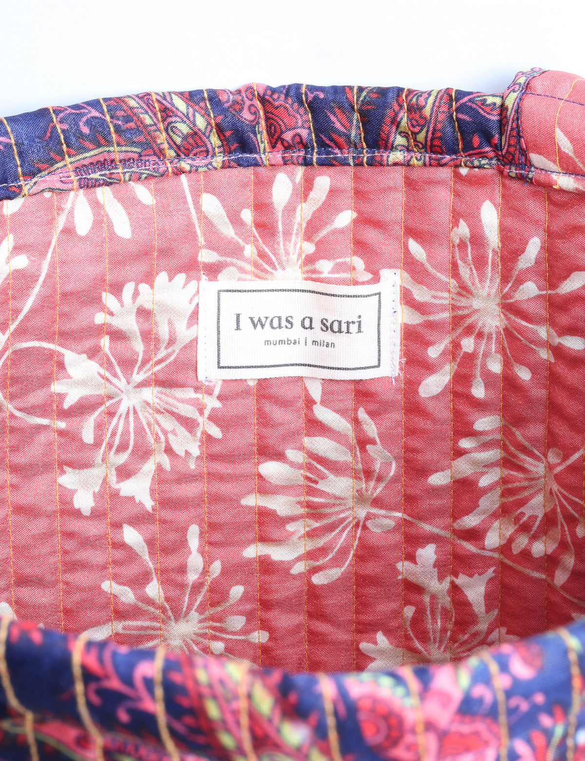 Elevate your style sustainably with our QUILTED SHOPPER BAG. Soft textures, vibrant colors, and a positive impact on people and the planet. Perfect for the office, shopping, or happy hour. Crafted from pre-loved saris for eco-conscious fashionistas!