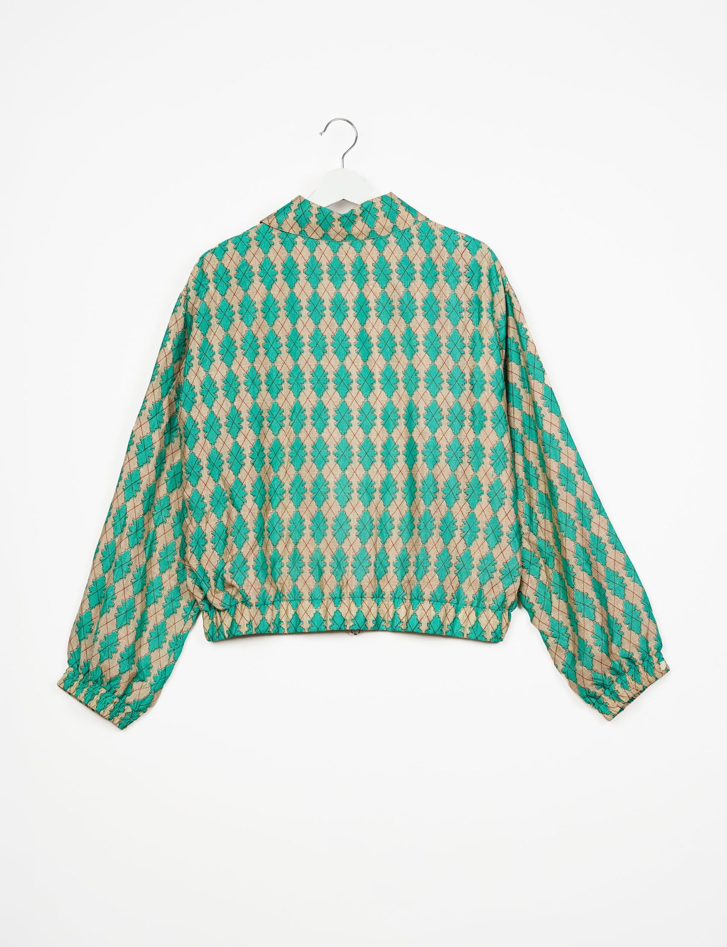 Stylish BOMBER JACKET, an upcycled clothing masterpiece with a cute cropped shape, elasticated details, and detachable metallic zipper. Contrast sari print lining adds a unique touch. Explore sustainable and eco-friendly fashion.