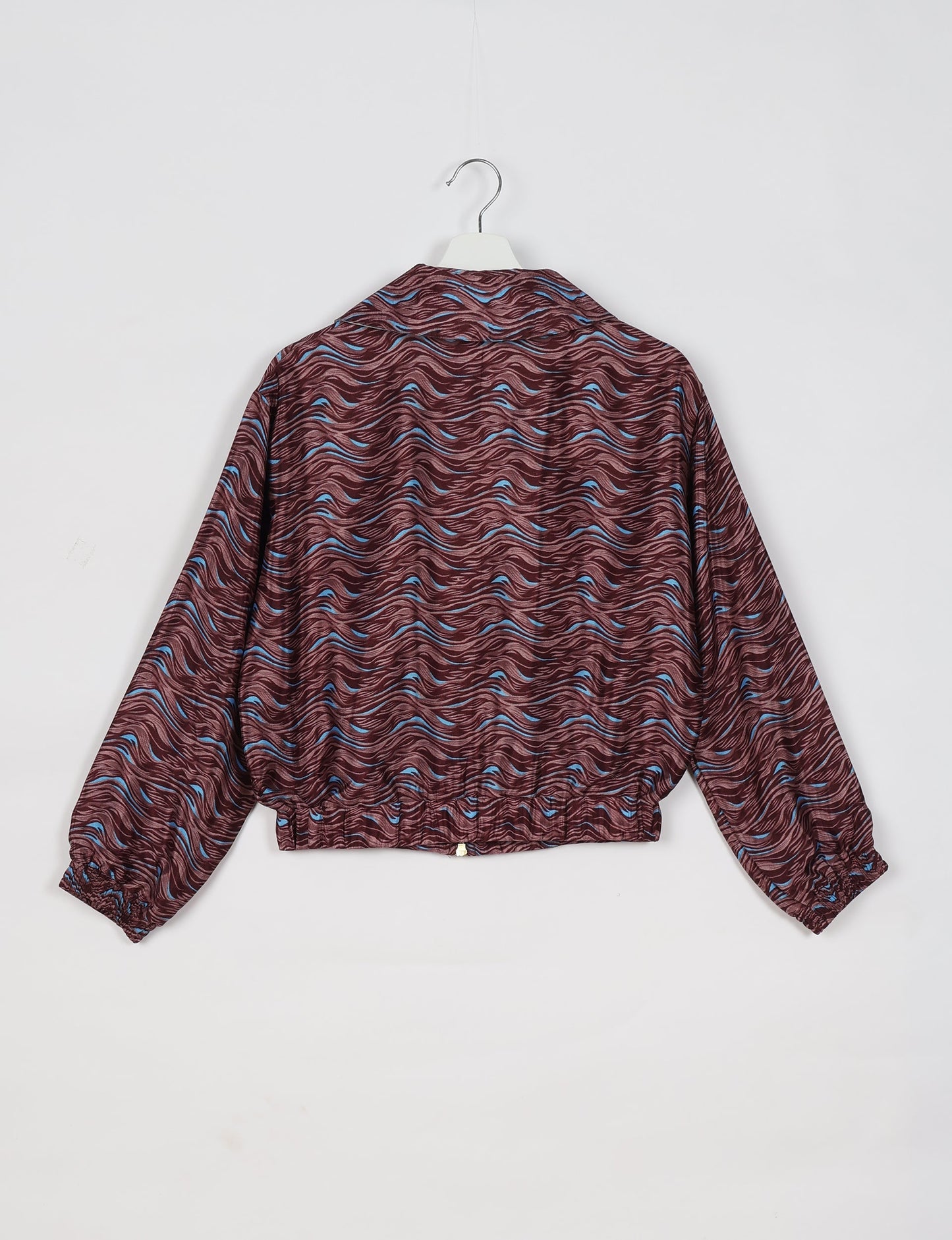 Upcycled Bomber Jacket made from recycled sari materials, featuring a cute cropped shape, elasticated hem and cuffs, and contrast sari print lining. Sustainable apparel promoting eco-friendly fashion and ethical clothing.