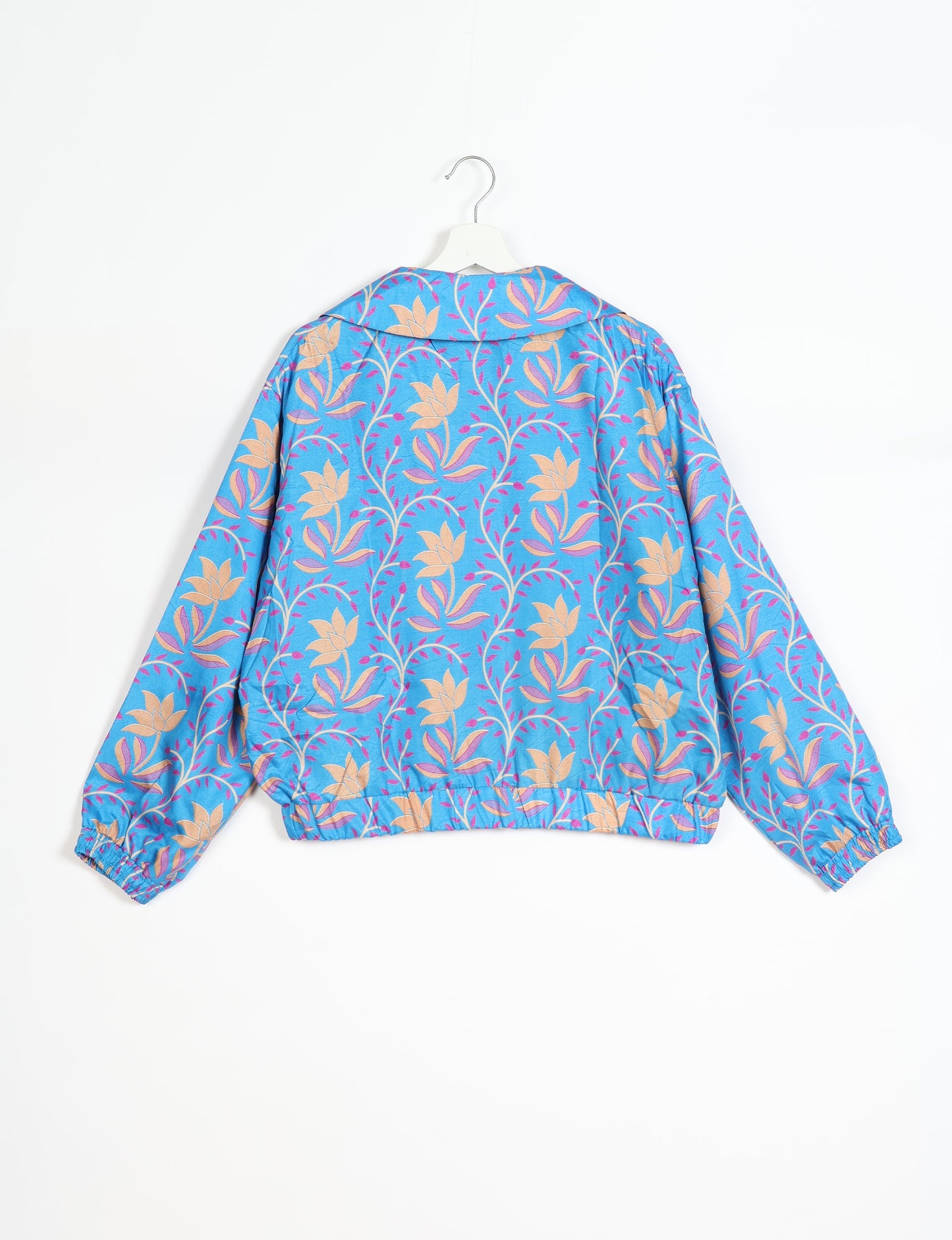 Stylish BOMBER JACKET, an upcycled clothing masterpiece with a cute cropped shape, elasticated details, and detachable metallic zipper. Contrast sari print lining adds a unique touch. Explore sustainable and eco-friendly fashion.