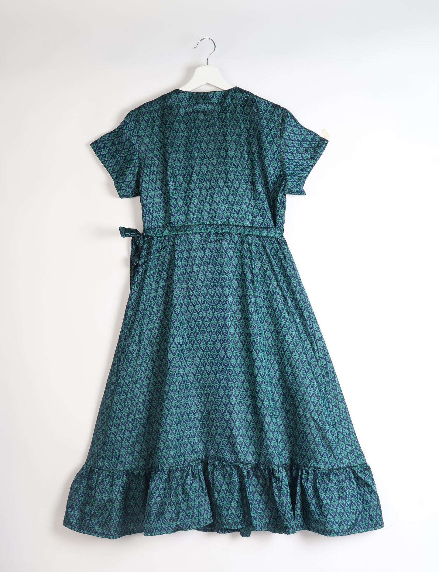 Embrace timeless elegance with our MIDI WRAP DRESS – a midi-length beauty featuring a v-neck, flattery from all angles, and a charming sari belt. Crafted from sustainable materials, this dress embodies ethical clothing and green fashion. Sophisticated with a frill tier at the hem and short cap sleeves, this dress is perfect for any occasion. Tie up the beautifully crafted sari belt on the side for a versatile, stylish, and eco-friendly look.