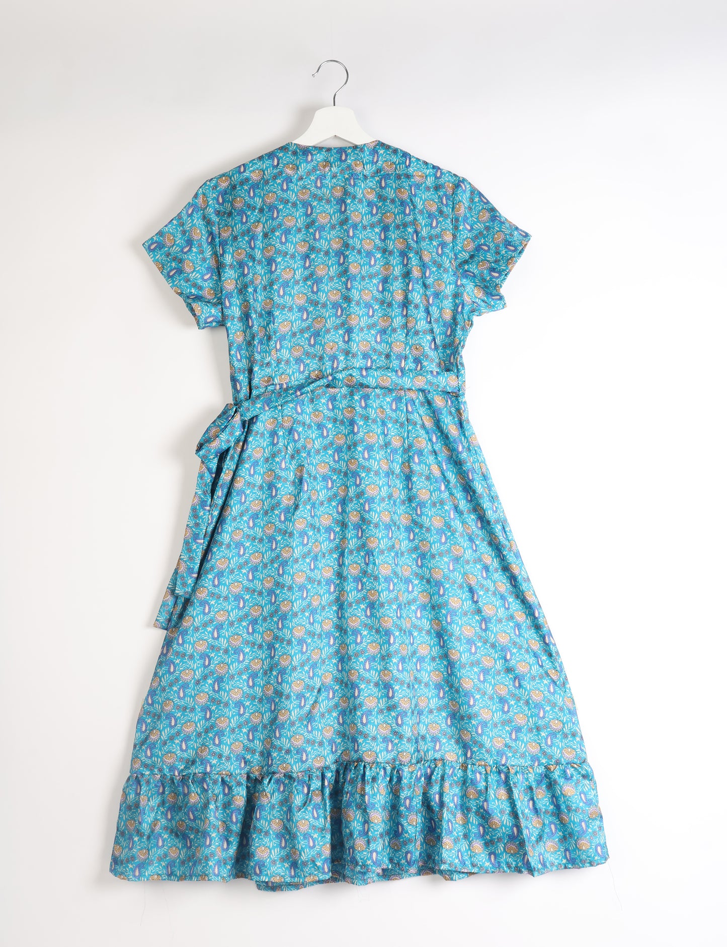 Embrace timeless elegance with our MIDI WRAP DRESS – a midi-length beauty featuring a v-neck, flattery from all angles, and a charming sari belt. Crafted from sustainable materials, this dress embodies ethical clothing and green fashion. Sophisticated with a frill tier at the hem and short cap sleeves, this dress is perfect for any occasion. Tie up the beautifully crafted sari belt on the side for a versatile, stylish, and eco-friendly look.