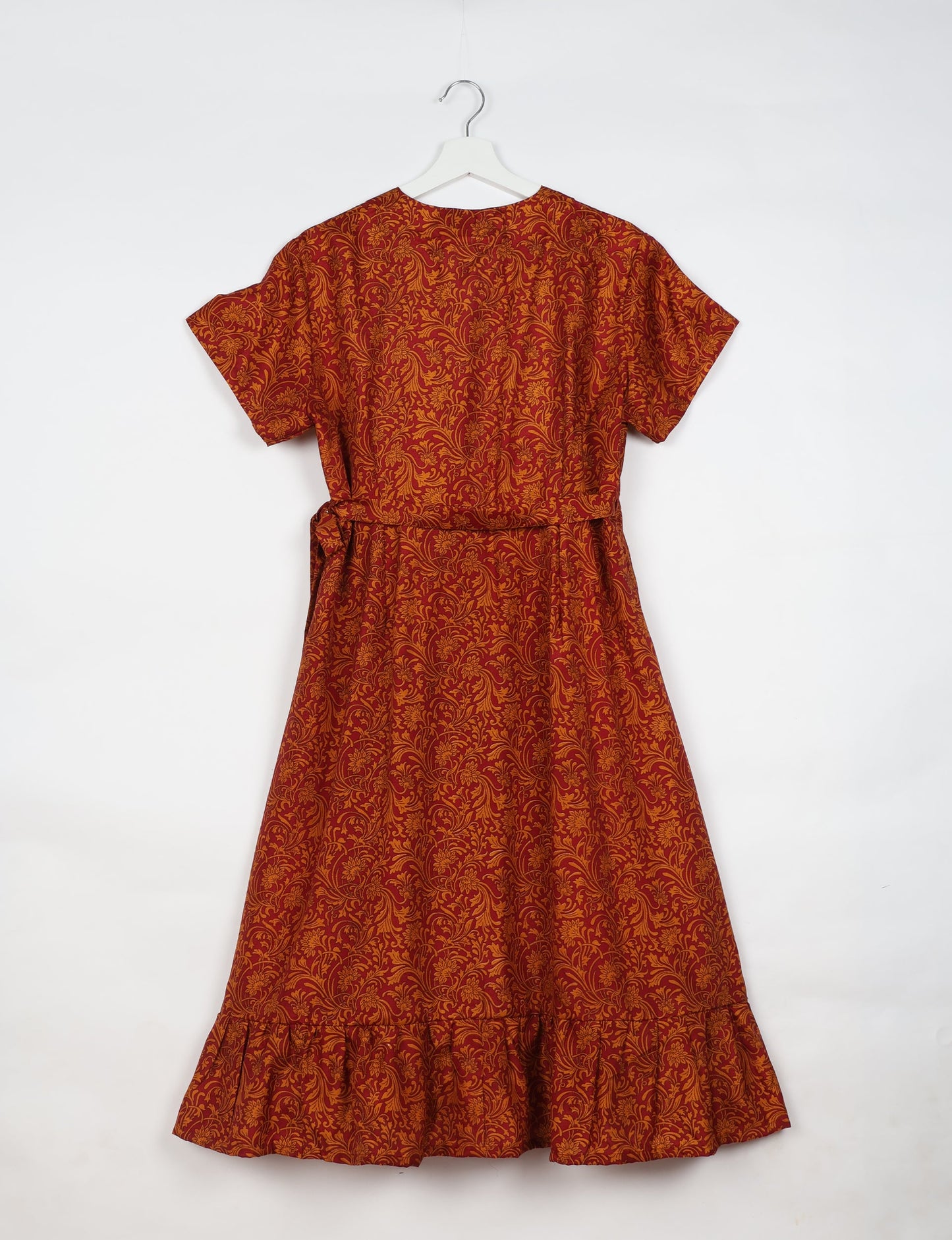 Embrace timeless elegance with our MIDI WRAP DRESS – a midi-length beauty featuring a v-neck, flattery from all angles, and a charming sari belt. Crafted from sustainable materials, this dress embodies ethical clothing and green fashion. Sophisticated with a frill tier at the hem and short cap sleeves, this dress is perfect for any occasion. Tie up the beautifully crafted sari belt on the side for a versatile, stylish, and eco-friendly look.