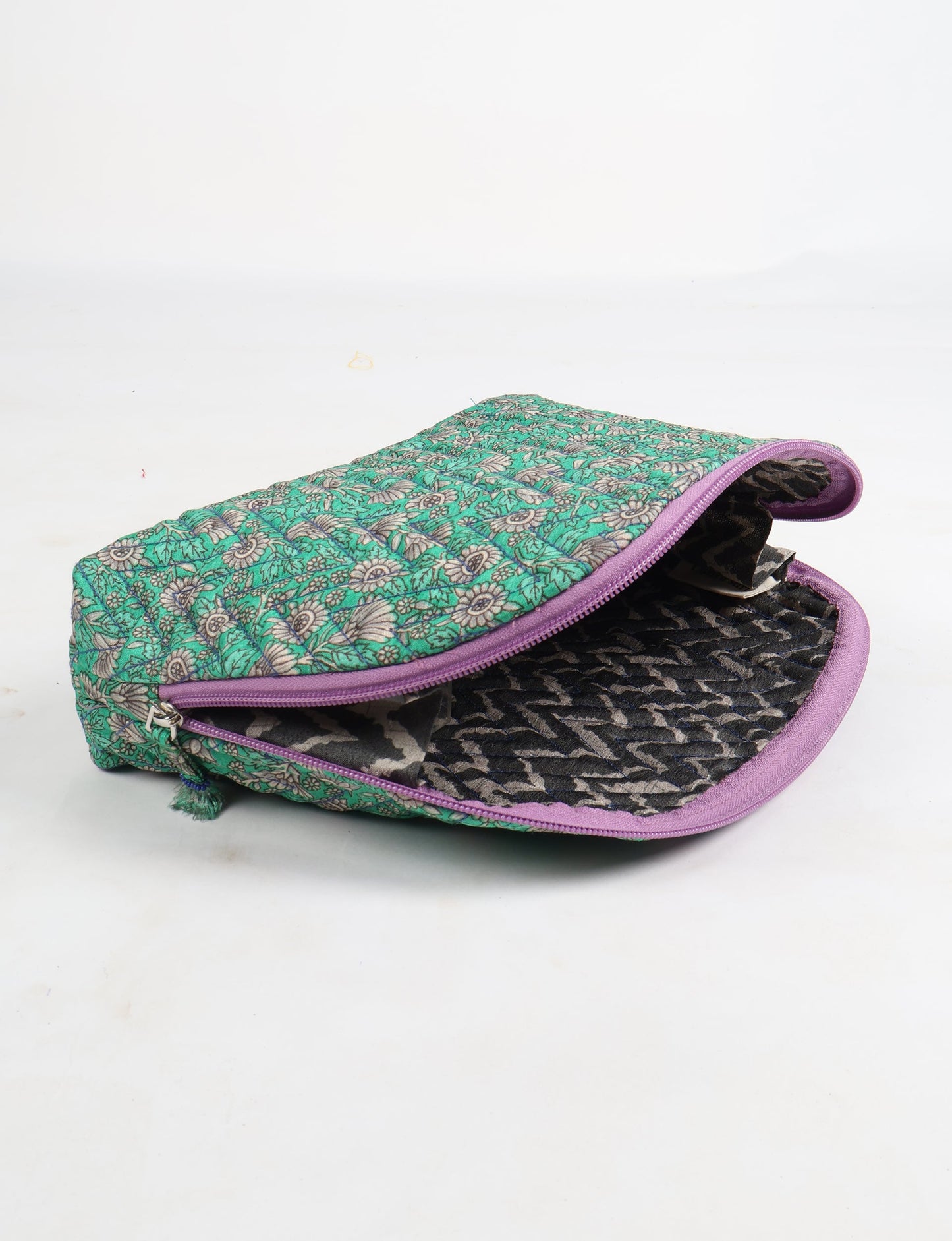A set of two Vanity Pouches, featuring embellished beaded pullers, made from sustainable materials for eco-conscious travelers.