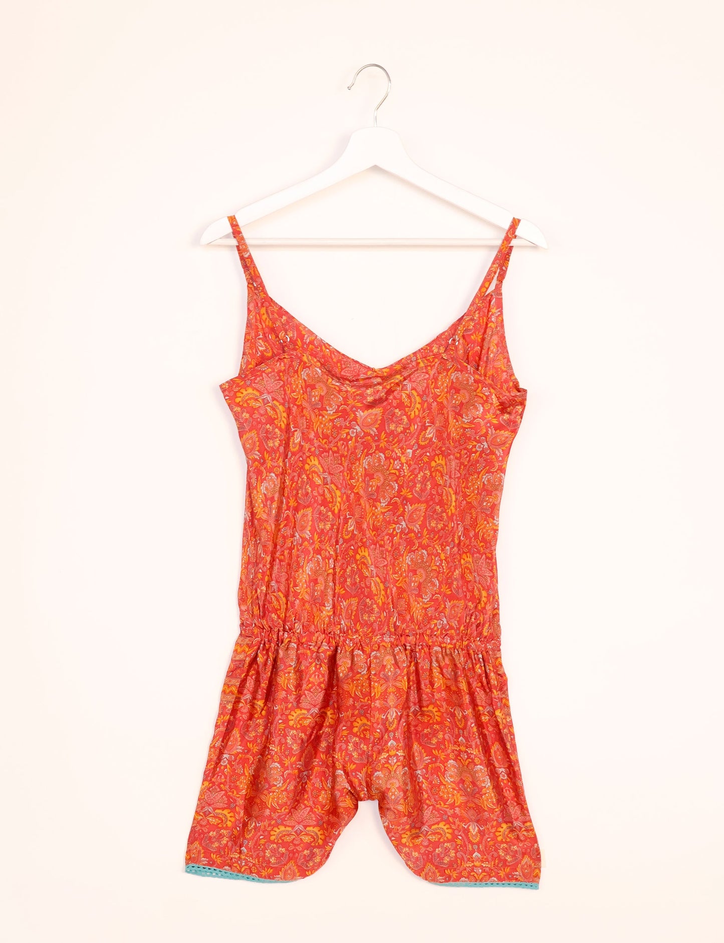 Vibrant playsuit with lace accents, crafted from upcycled saris. Embrace ethical fashion with this unique piece designed for conscious consumers.
