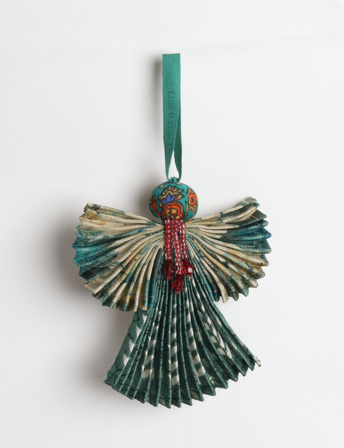Angel Christmas Ornament made from upcycled saris, featuring pleated arms and body. A sustainable, eco-friendly holiday decoration, embodying recycled fashion and upcycling in festive style.