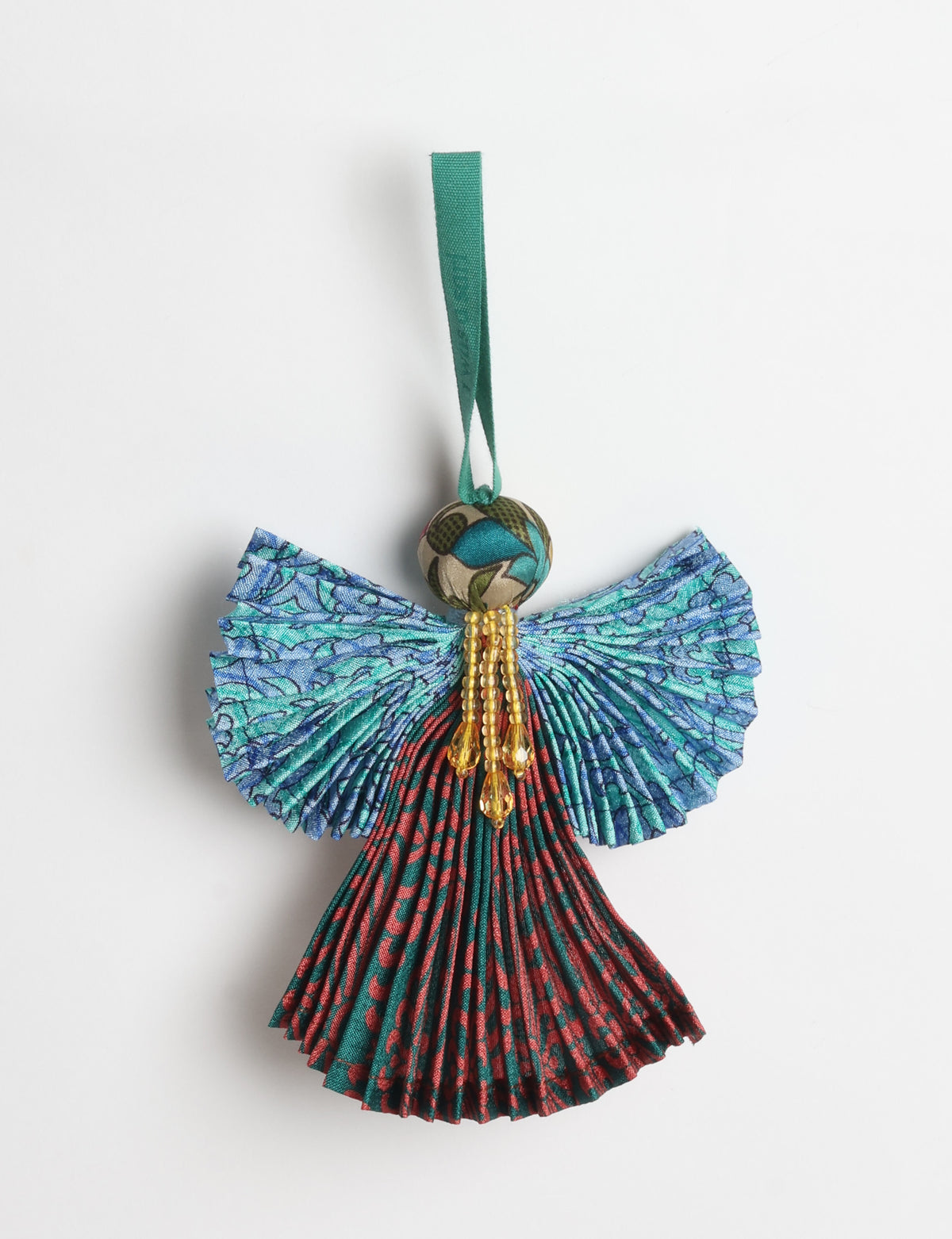 Angel Christmas Ornament made from upcycled saris, featuring pleated arms and body. A sustainable, eco-friendly holiday decoration, embodying recycled fashion and upcycling in festive style.