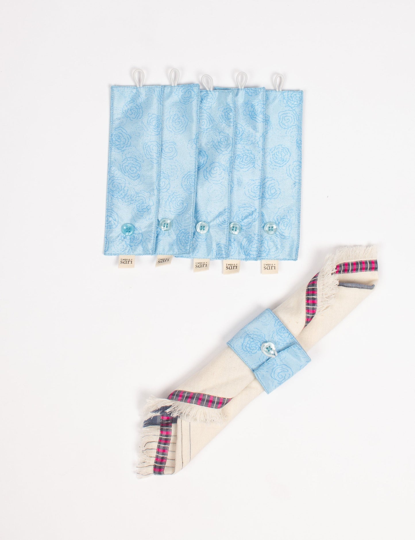 A set of 6 napkin rings made from repurposed saris, showcasing the beauty of sustainable fashion and upcycled materials. These stylish, eco-friendly rings with button closures are ideal for adding a touch of environmentally conscious elegance to your dining table.