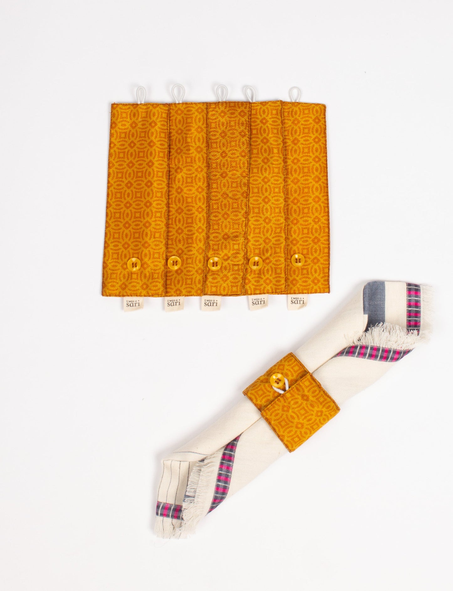 A set of 6 napkin rings made from repurposed saris, showcasing the beauty of sustainable fashion and upcycled materials. These stylish, eco-friendly rings with button closures are ideal for adding a touch of environmentally conscious elegance to your dining table.