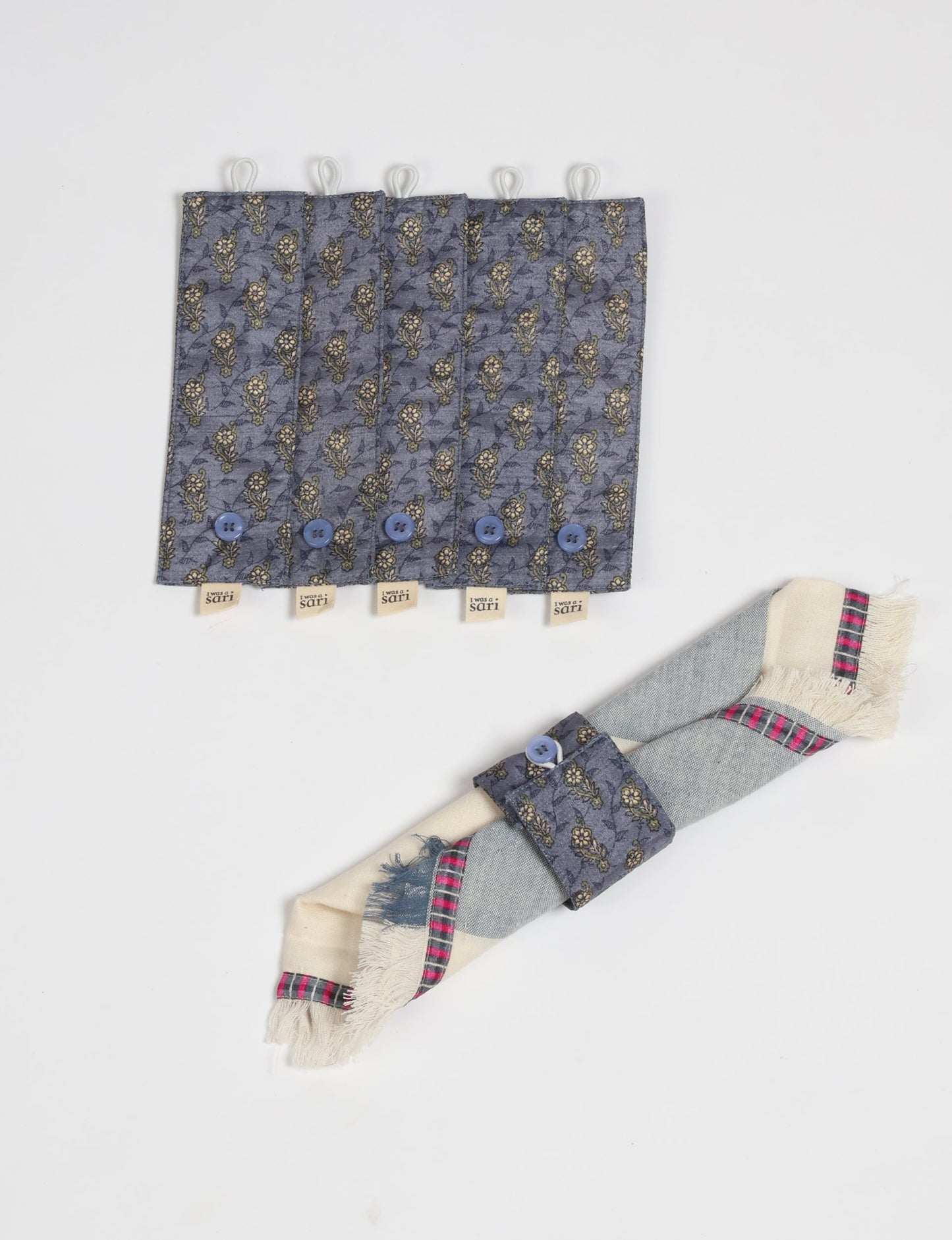 A set of 6 napkin rings made from repurposed saris, showcasing the beauty of sustainable fashion and upcycled materials. These stylish, eco-friendly rings with button closures are ideal for adding a touch of environmentally conscious elegance to your dining table.