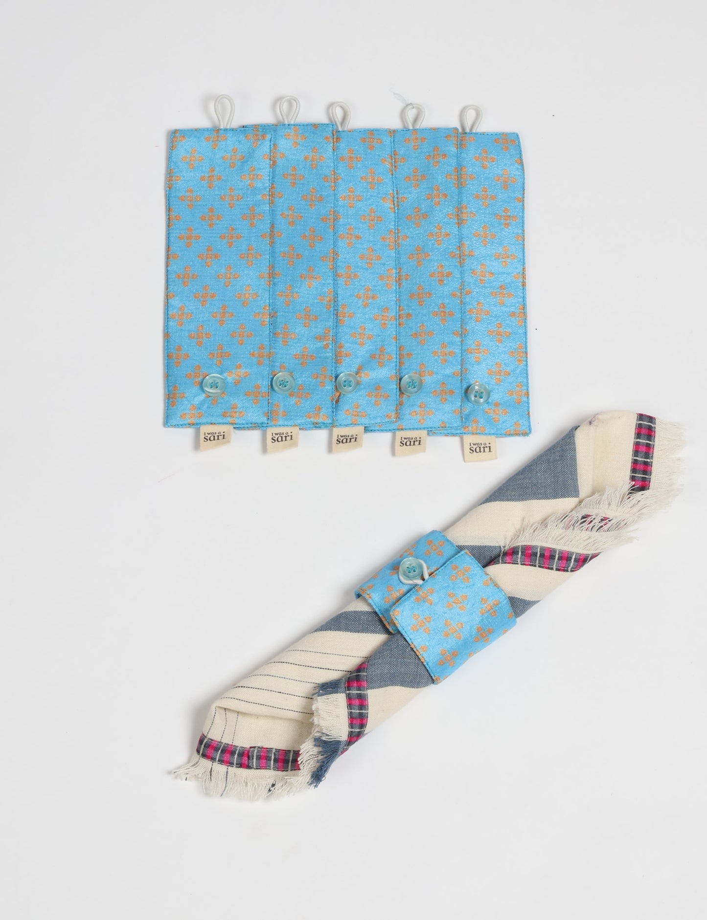 A set of 6 napkin rings made from repurposed saris, showcasing the beauty of sustainable fashion and upcycled materials. These stylish, eco-friendly rings with button closures are ideal for adding a touch of environmentally conscious elegance to your dining table.