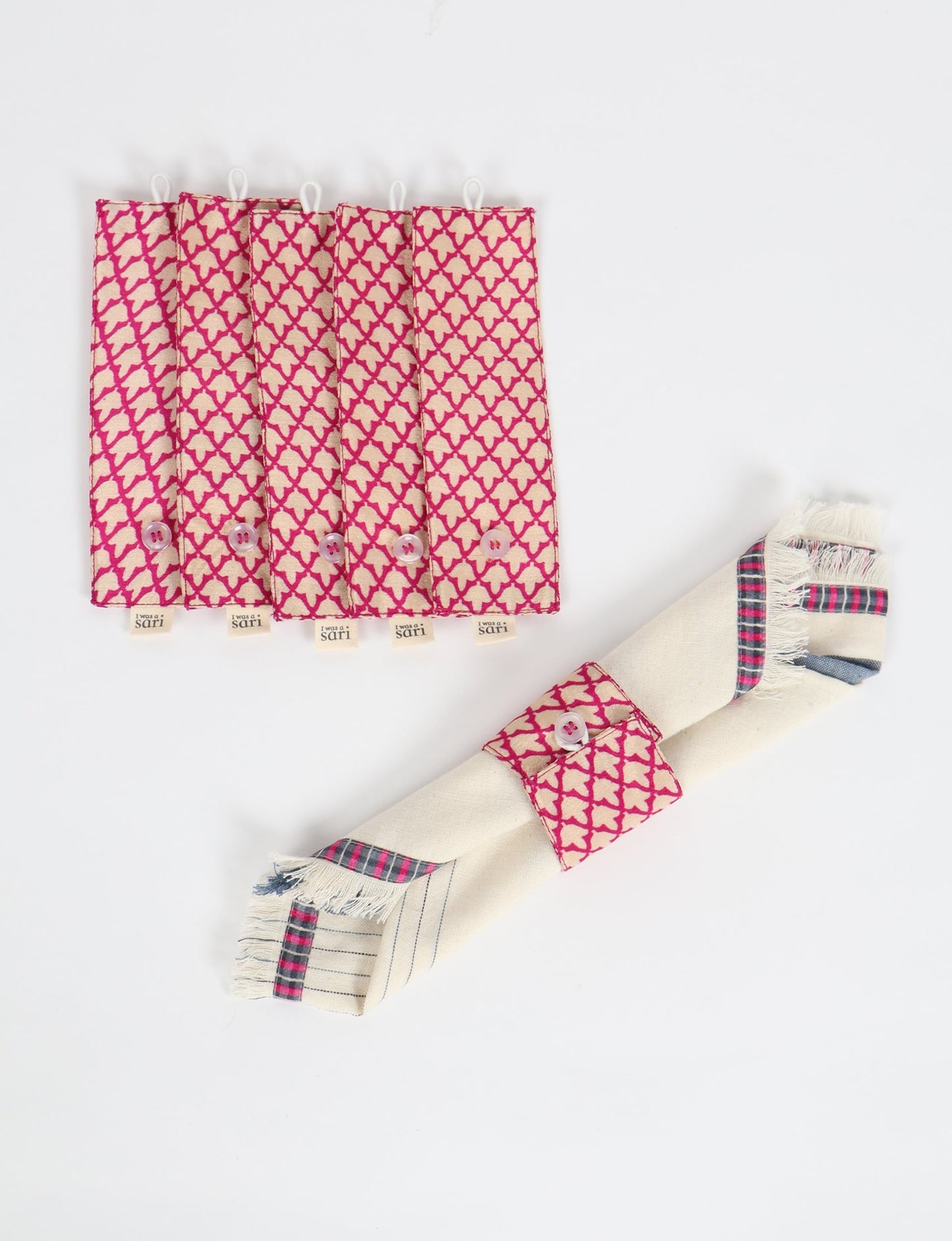 A set of 6 napkin rings made from repurposed saris, showcasing the beauty of sustainable fashion and upcycled materials. These stylish, eco-friendly rings with button closures are ideal for adding a touch of environmentally conscious elegance to your dining table.