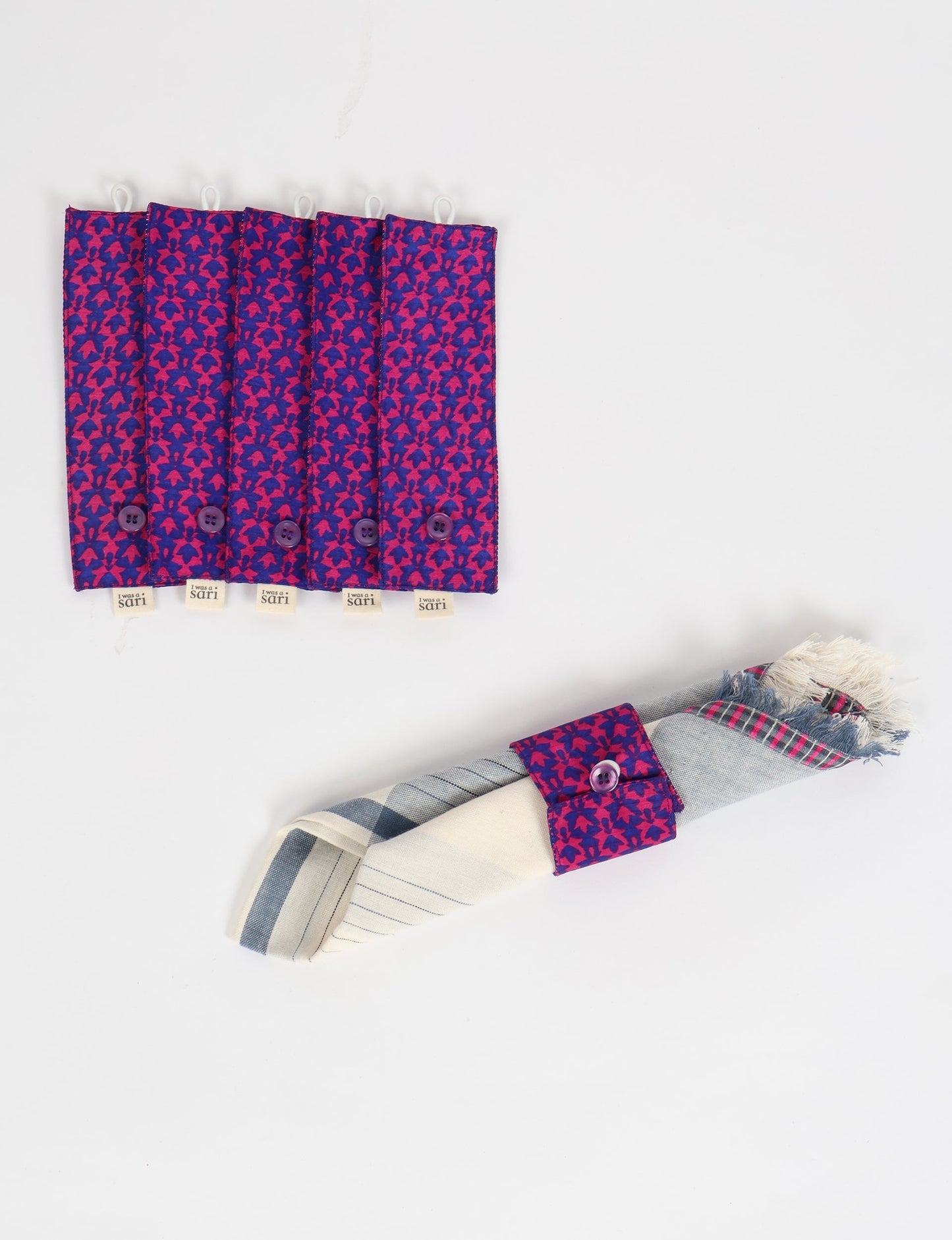 A set of 6 napkin rings made from repurposed saris, showcasing the beauty of sustainable fashion and upcycled materials. These stylish, eco-friendly rings with button closures are ideal for adding a touch of environmentally conscious elegance to your dining table.