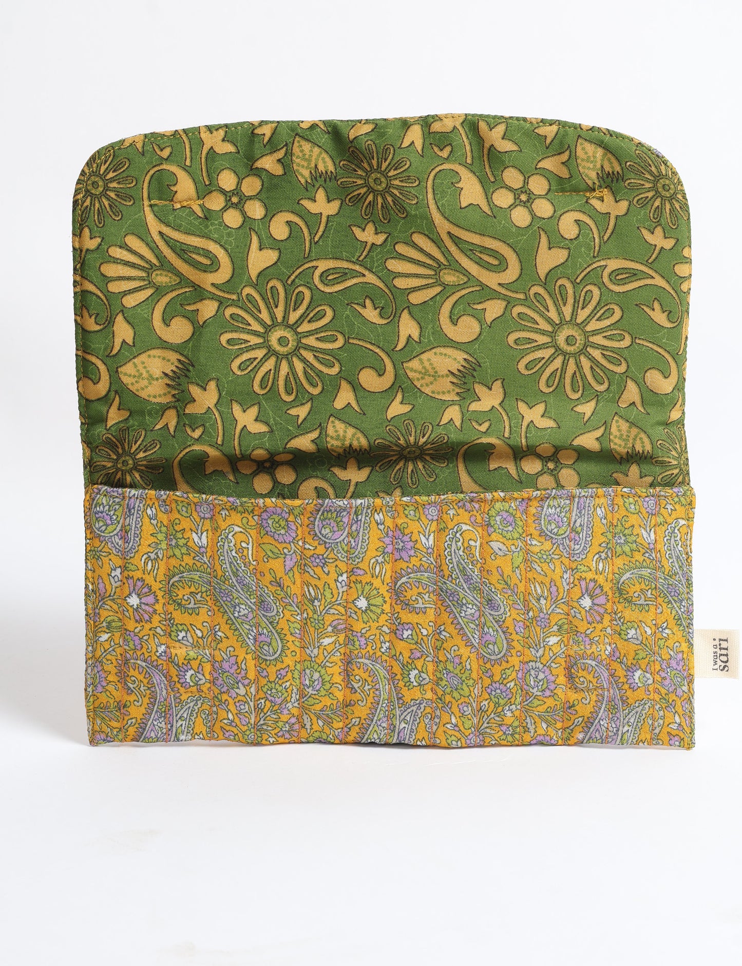 Quilted sunglasses case with yellow paisley exterior and green floral interior, flat lay with label tag visible