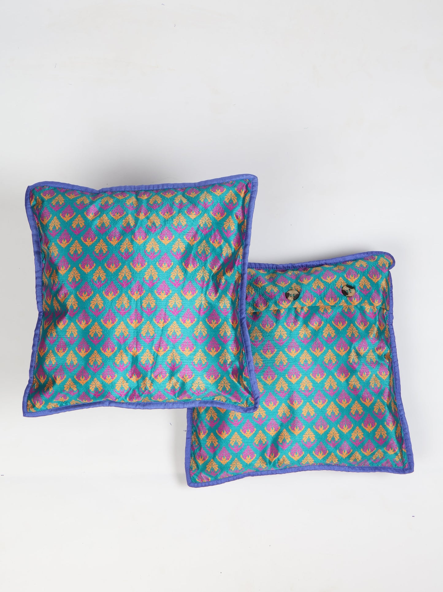 Cushion cover with piping edge made from recycled sari fabric, featuring a tailored look with three-button closure. An elegant piece of ethical fashion, promoting conscious clothing, recycled fashion, and sustainable products.
