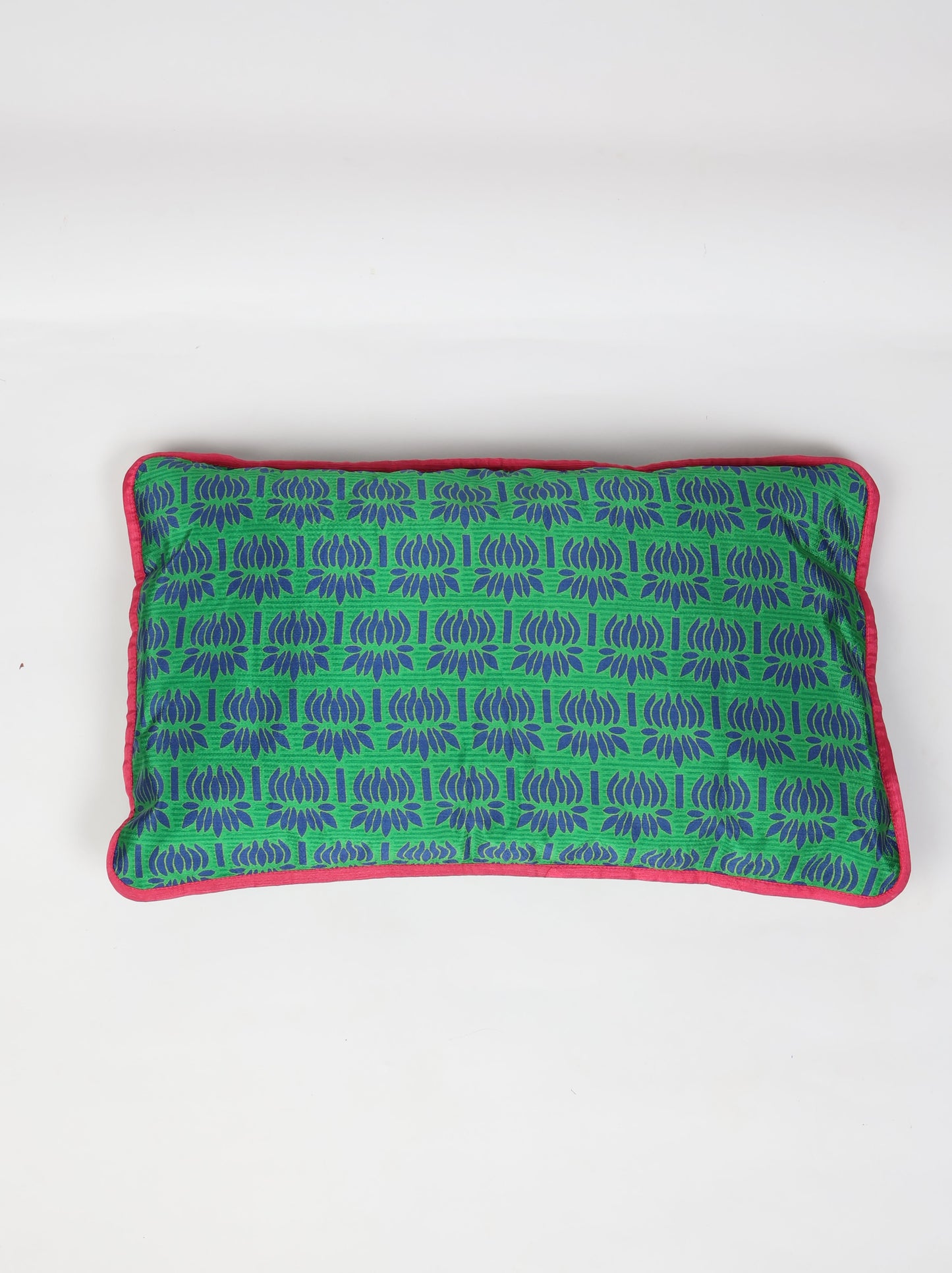 An eco-friendly Lumbar Cushion Cover with piping edge made from recycled saris. Featuring a stylish five-button closure, this sustainable fashion piece highlights upcycled women's clothing, eco-friendly cloth, carbon-neutral fashion, and natural clothing. A beautiful recycled sari product promoting climate-neutral and environmentally friendly clothing.
