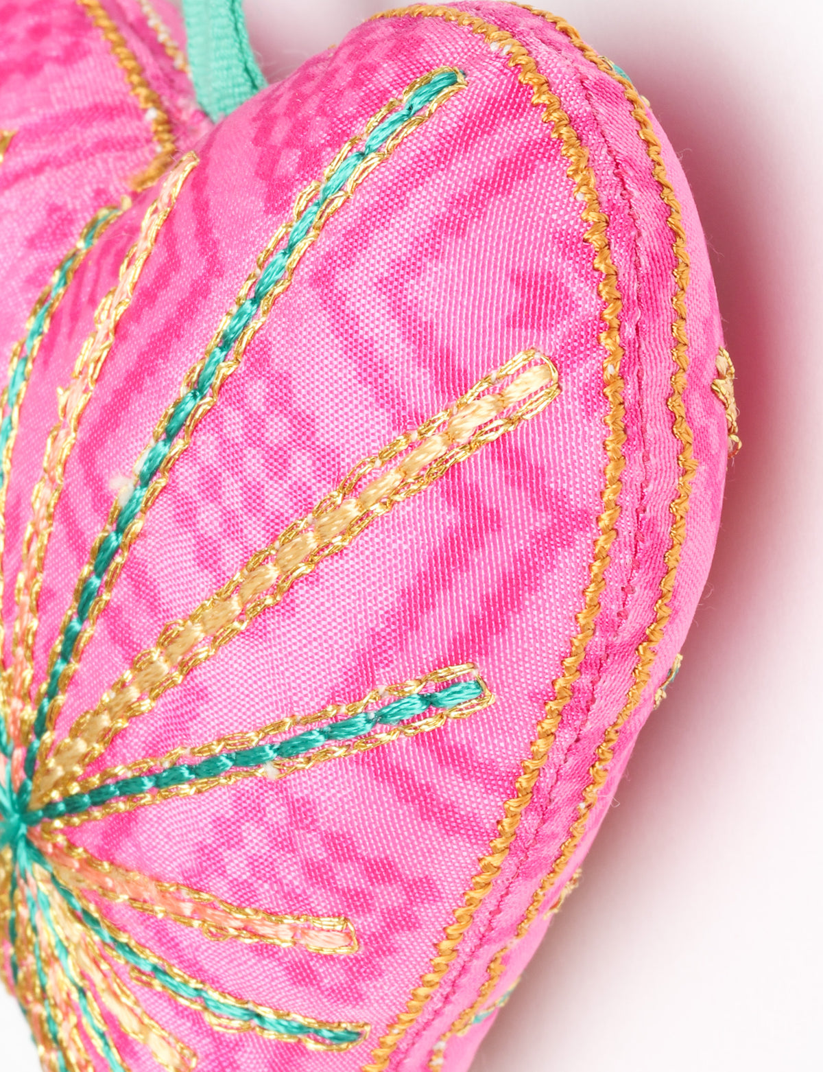 Timeless Heart ornament made from upcycled clothing and recycled fabric, filled with organic cotton and hand-finished with vibrant silk and metallic thread. An eco-friendly, carbon neutral fashion piece that supports green fashion and fair trade apparel.