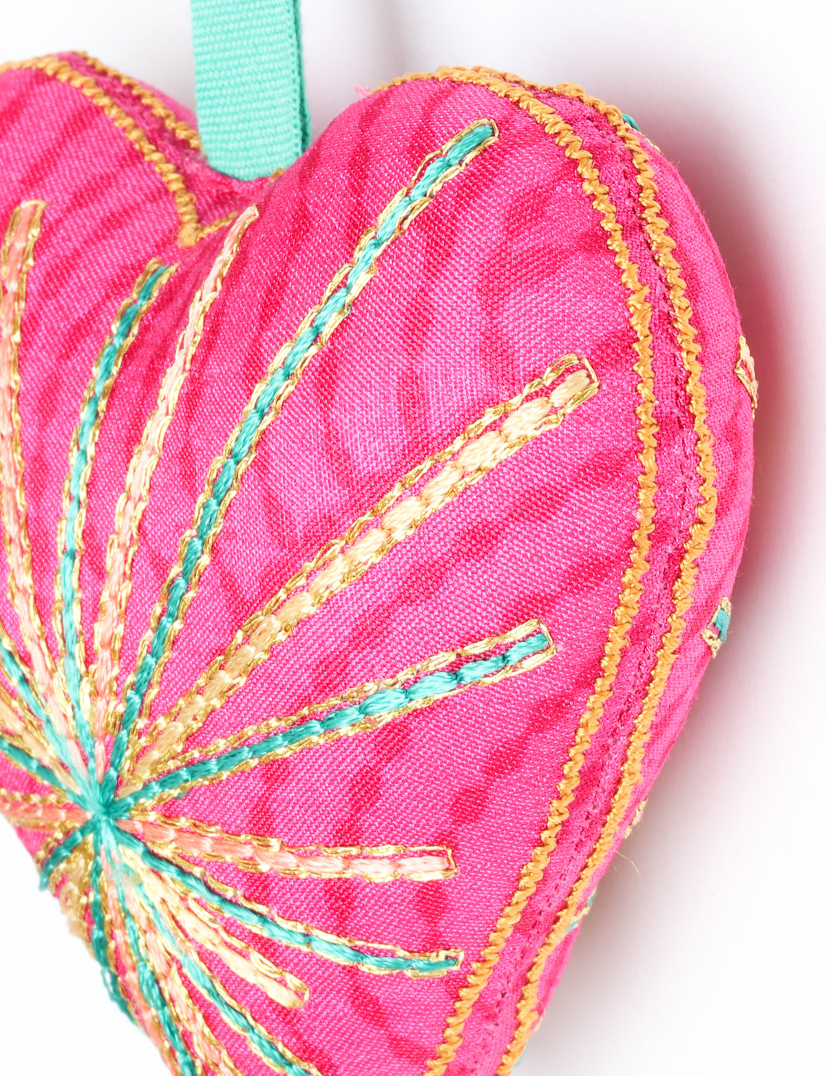Timeless Heart ornament made from upcycled clothing and recycled fabric, filled with organic cotton and hand-finished with vibrant silk and metallic thread. An eco-friendly, carbon neutral fashion piece that supports green fashion and fair trade apparel.