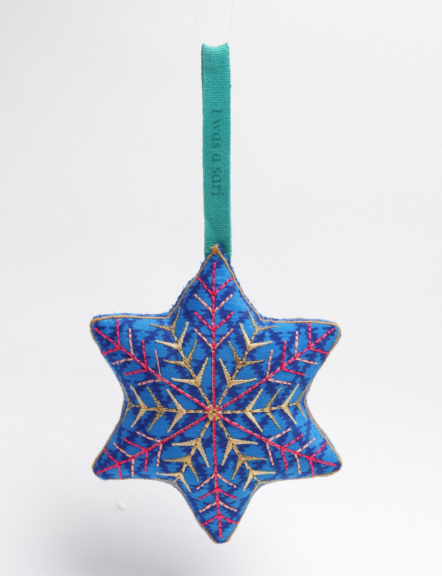 Timeless snowflake ornament made from preloved sari fabric with metallic embroidery, promoting green fashion, fair trade fashion, recycled material clothing, repurposed clothing, sustainable women's clothing, and circular fashion for a conscious lifestyle.