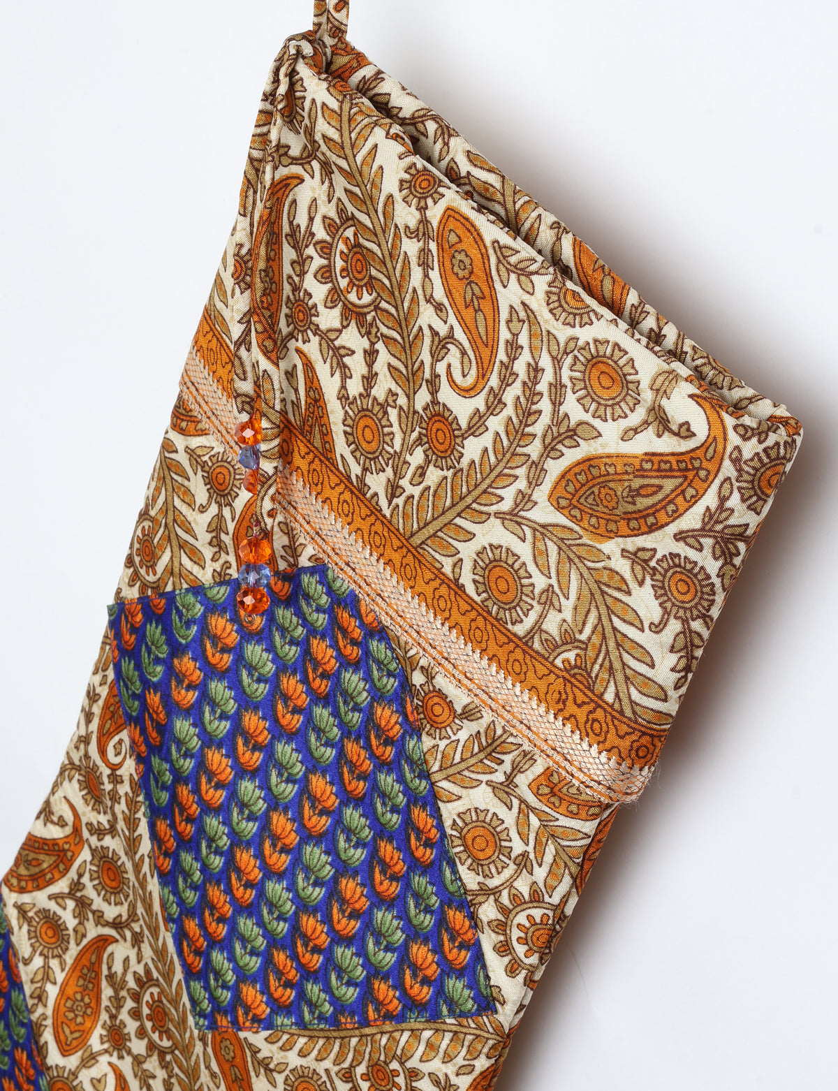 Timeless Christmas stocking made from recycled sari fabric, featuring colorful patchwork, tassel details, and crafted with care in line with circular fashion, upcycling fashion, carbon neutral clothing, and environmentally friendly clothing ideals ā a beautiful piece of repurposed clothing and eco clothing for sustainable womenās fashion.